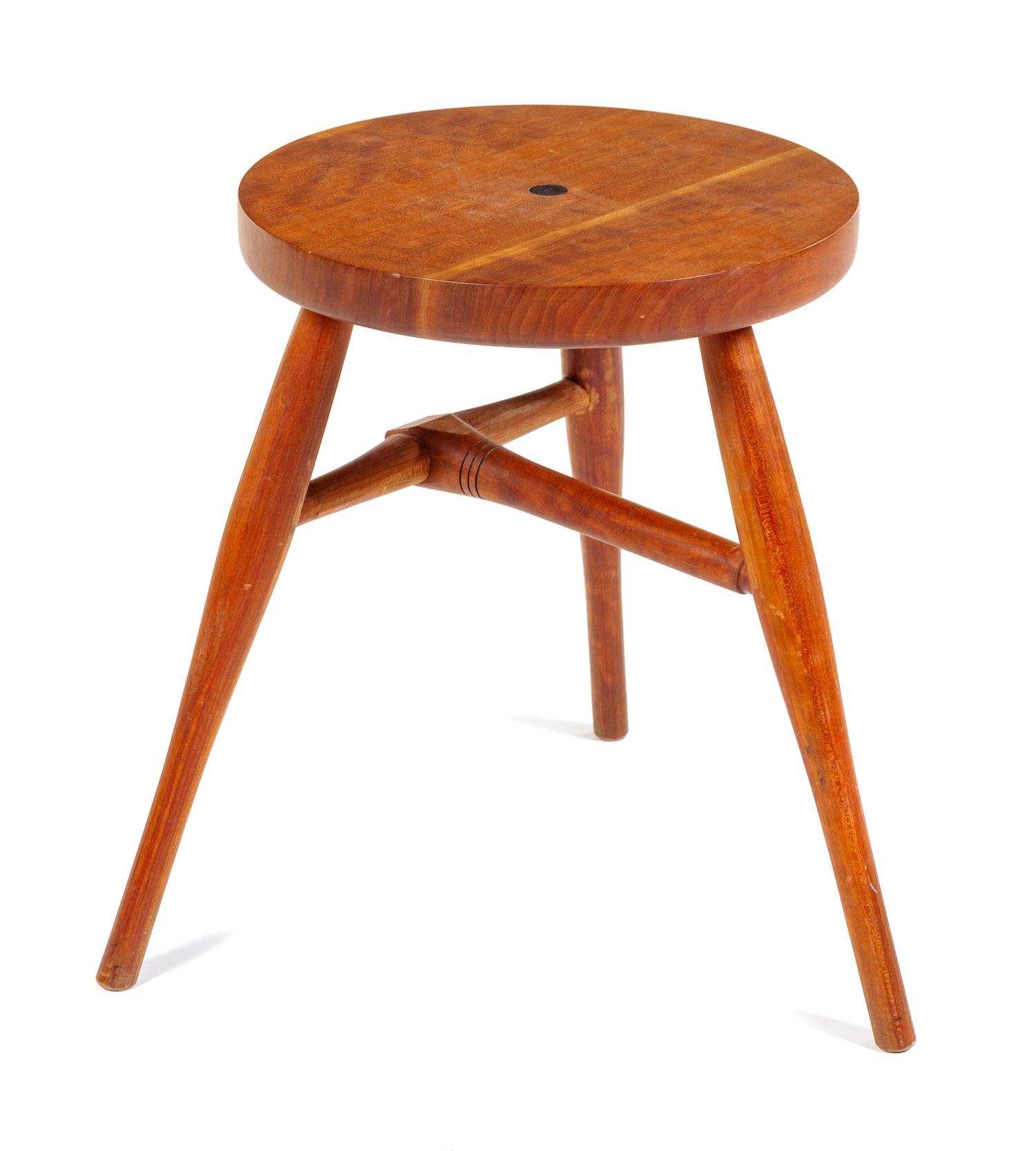 A Modern Stool, c. 20th Century, the circular seat centered by an inset designer logo and raised on three tapering cylindrical legs joi