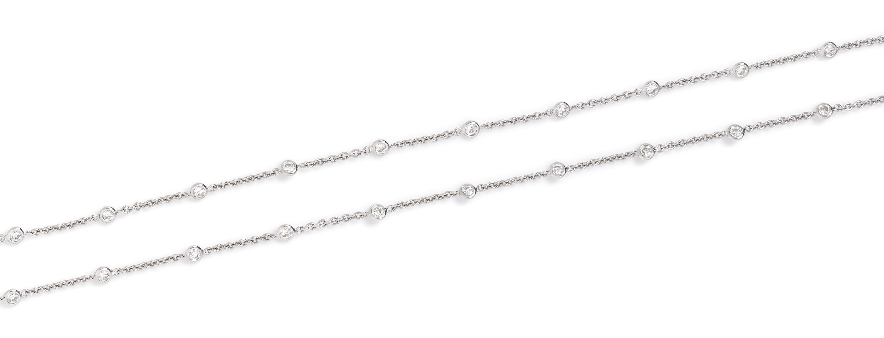 An 18 Karat White Gold and Diamond Station Necklace, 6.70 dwts.