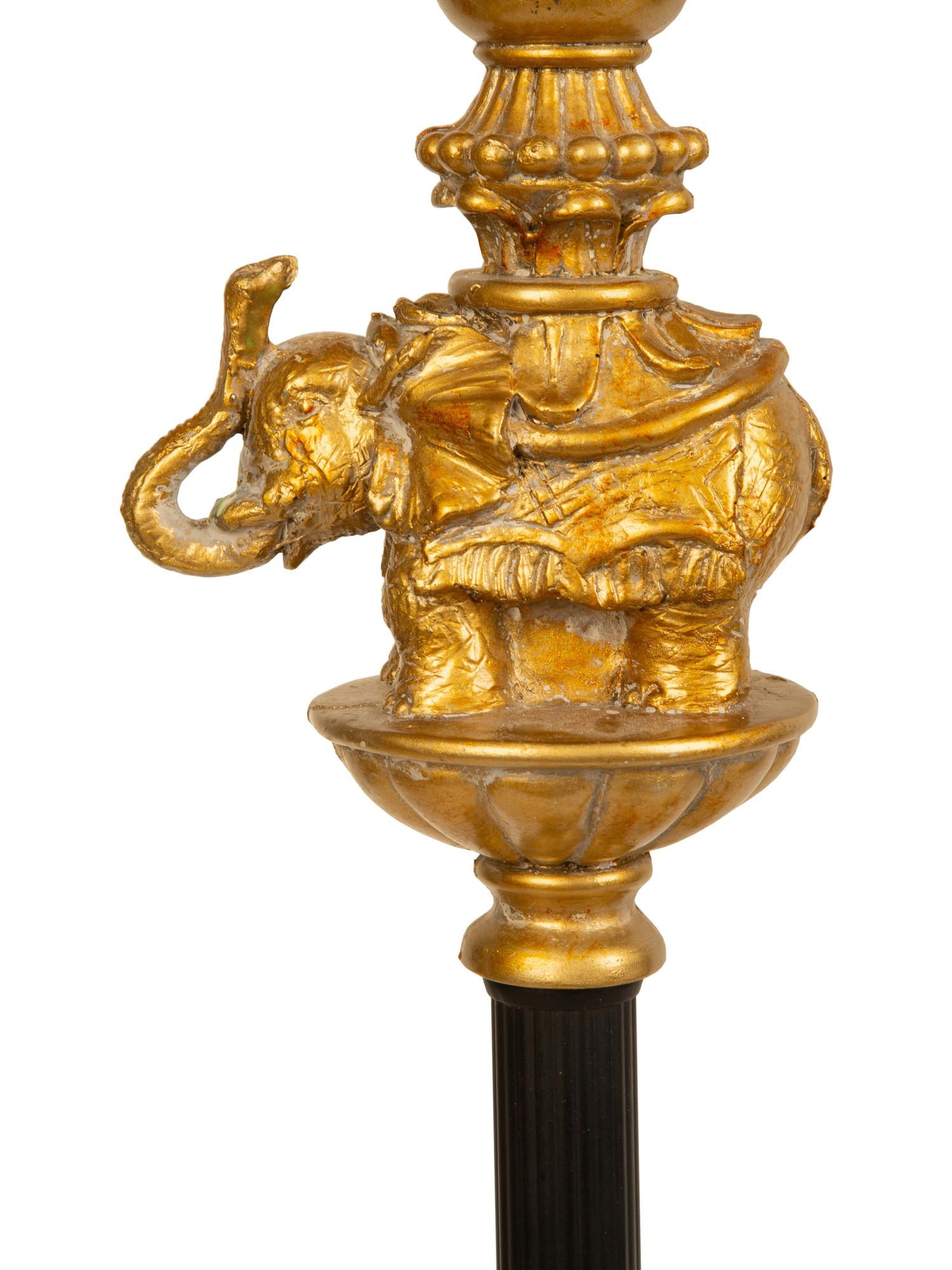 A Pair of Empire Style Ebonized and Gilt Metal Elephant Candlesticks now Mounted as Lamps — 20TH CENTURY