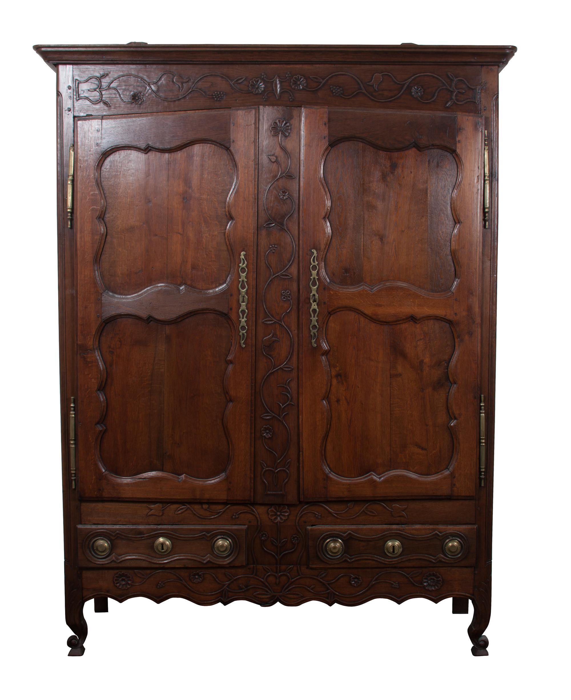 A French Relief Carved Oak Armoire Height 85 x width 61 x depth 21 inches.