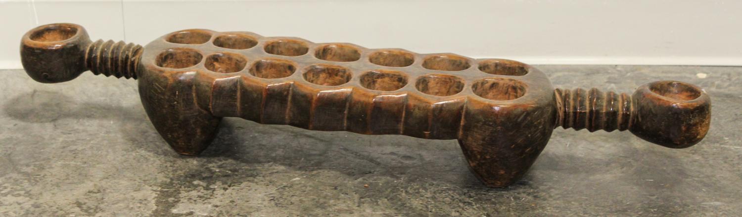 An African Carved Wood Mancala Board. Length 32 1/2 inches.