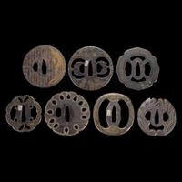 Group of seven Japanese inlaid iron tsuba Edo period or earlier