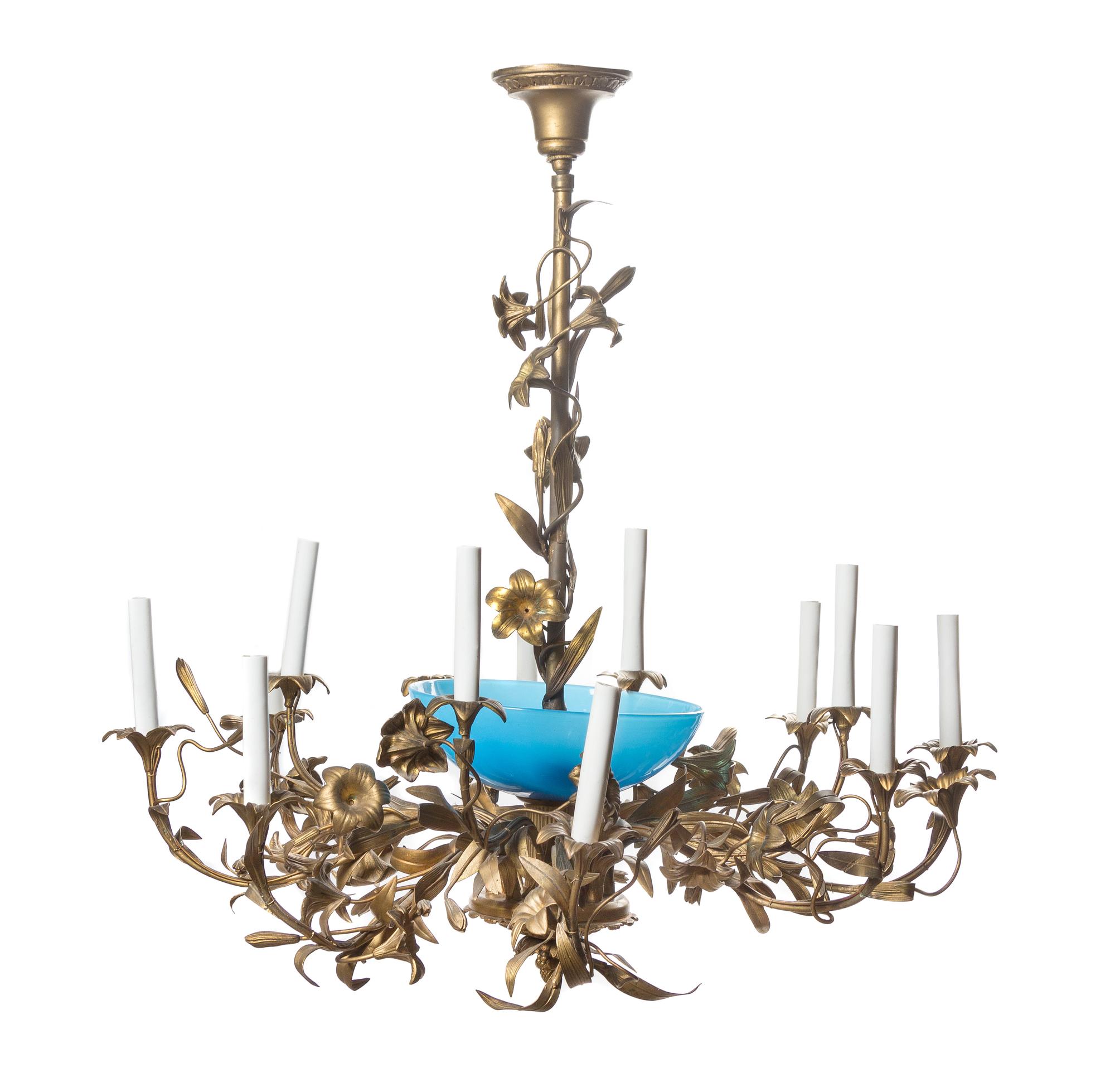 A Louis XV Style Gilt Bronze and Opaline Glass Twelve-Light Chandelier, Height 30 x diameter 32 inches.