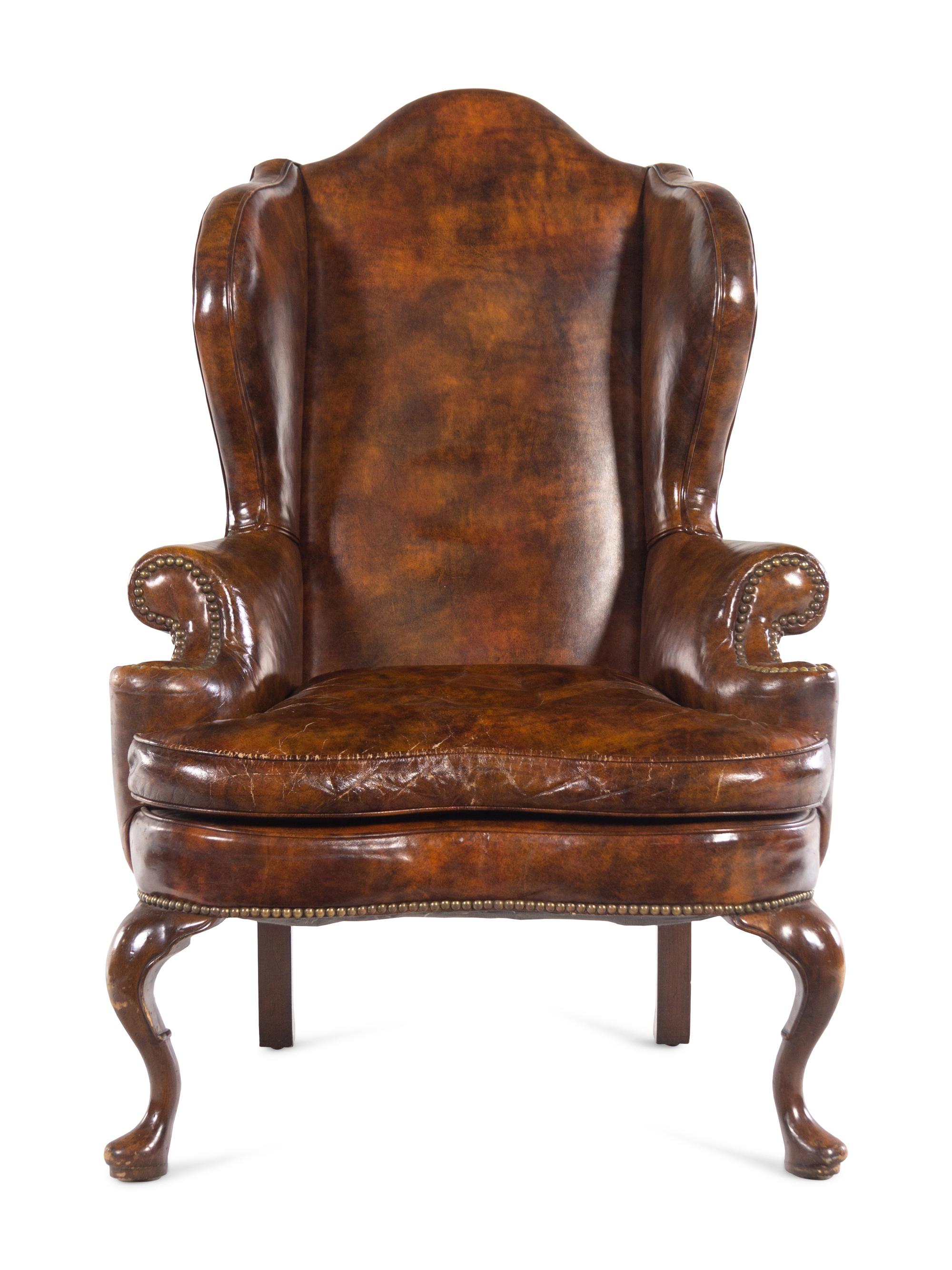 A Queen Anne Style Faux Leather Upholstered Wingback Armchair