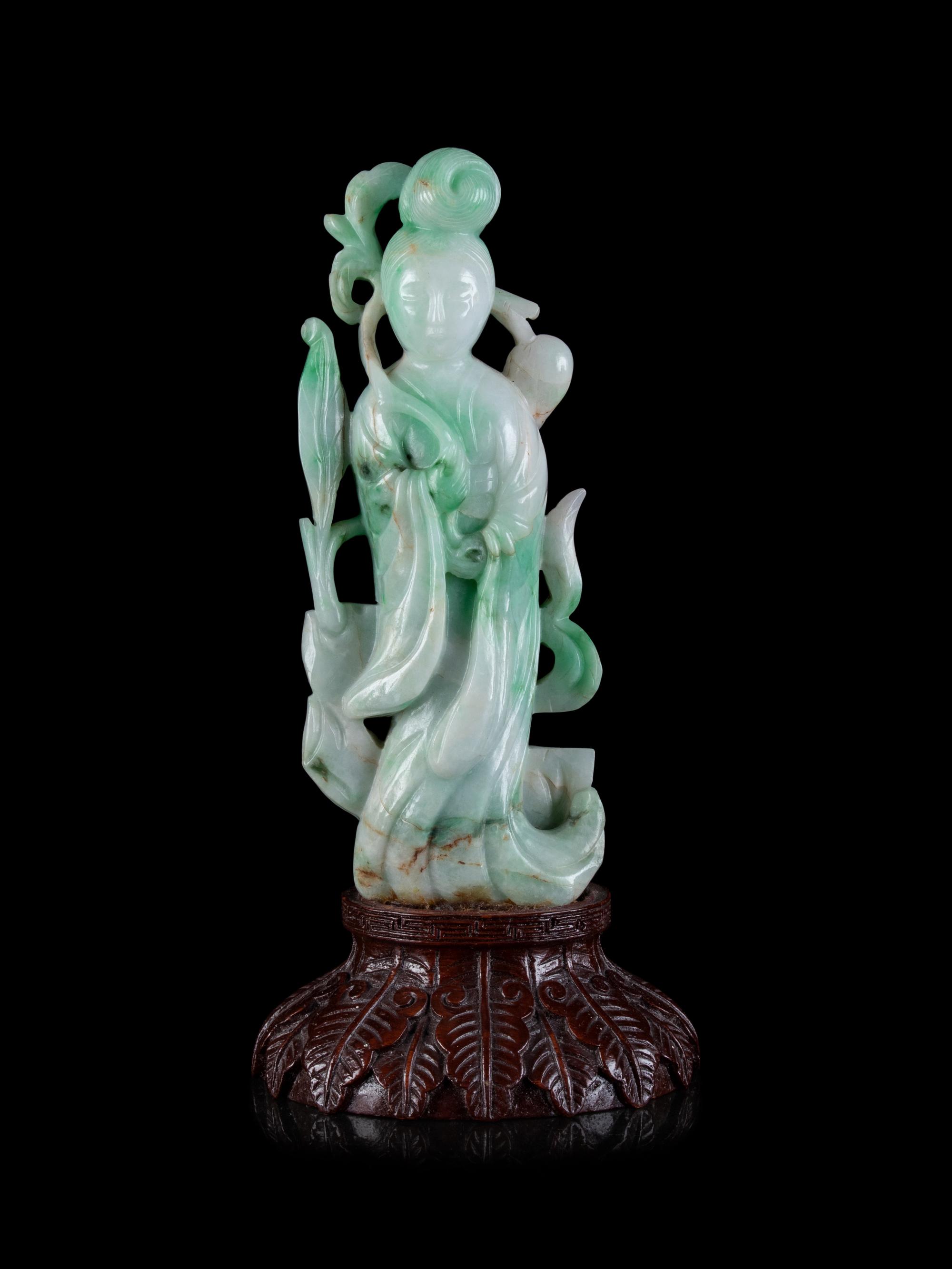 A Chinese Apple Green and Pale Celadon Jadeite Figure of Guanyin