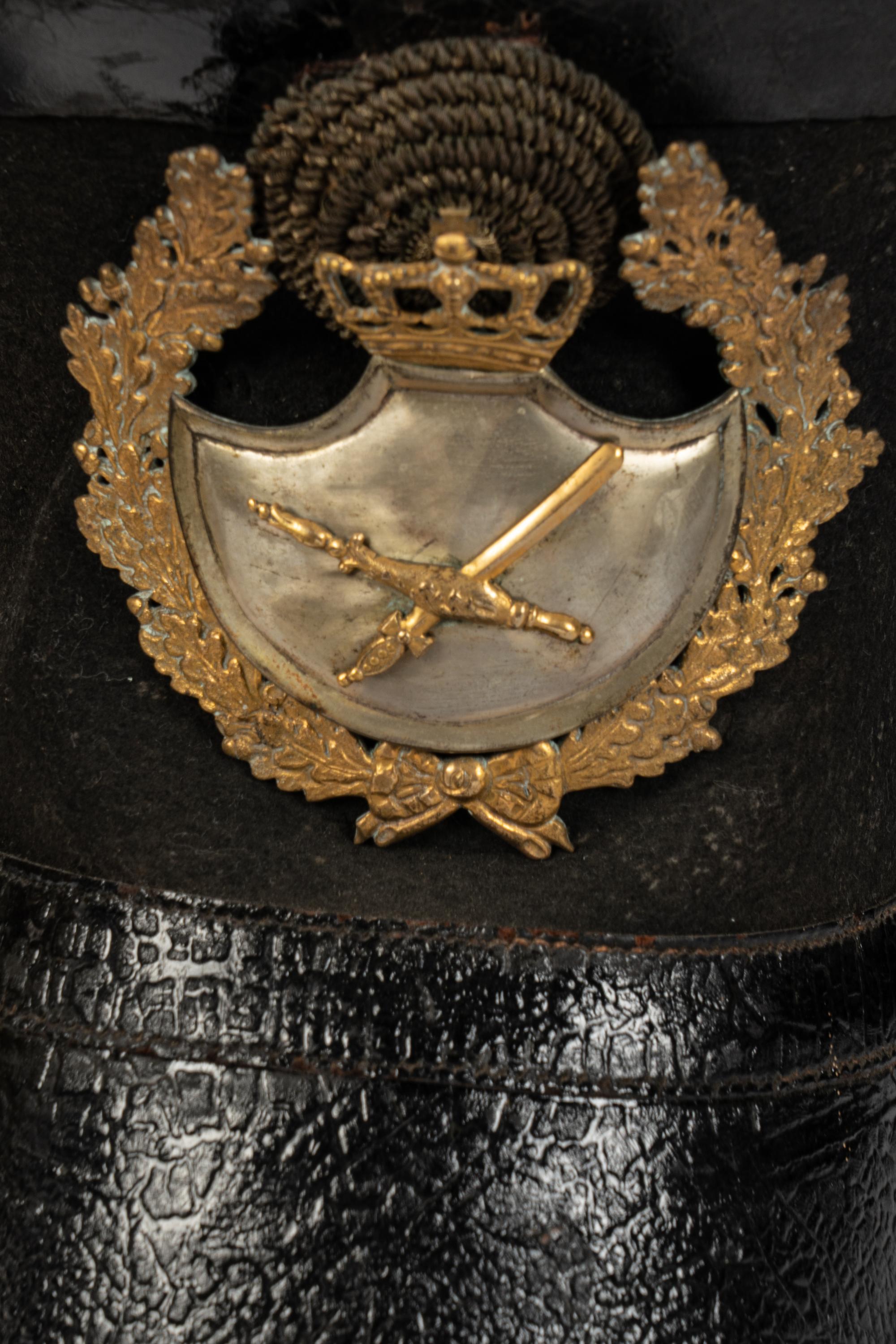 A Collection of Twenty-One Military Parade Helmets, Hats and Masks
