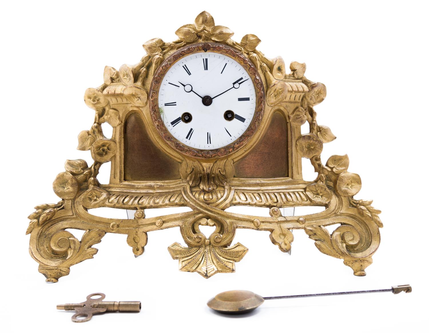 A Gilt Metal Clock Height 9 1/4 x width 12 1/2 inches.