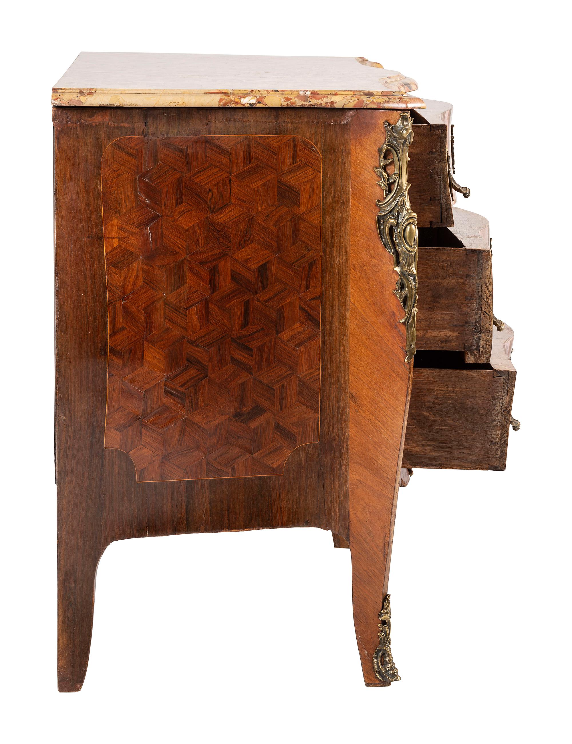 A Régence Style Bronze Mounted Marble Top Marquetry Commode