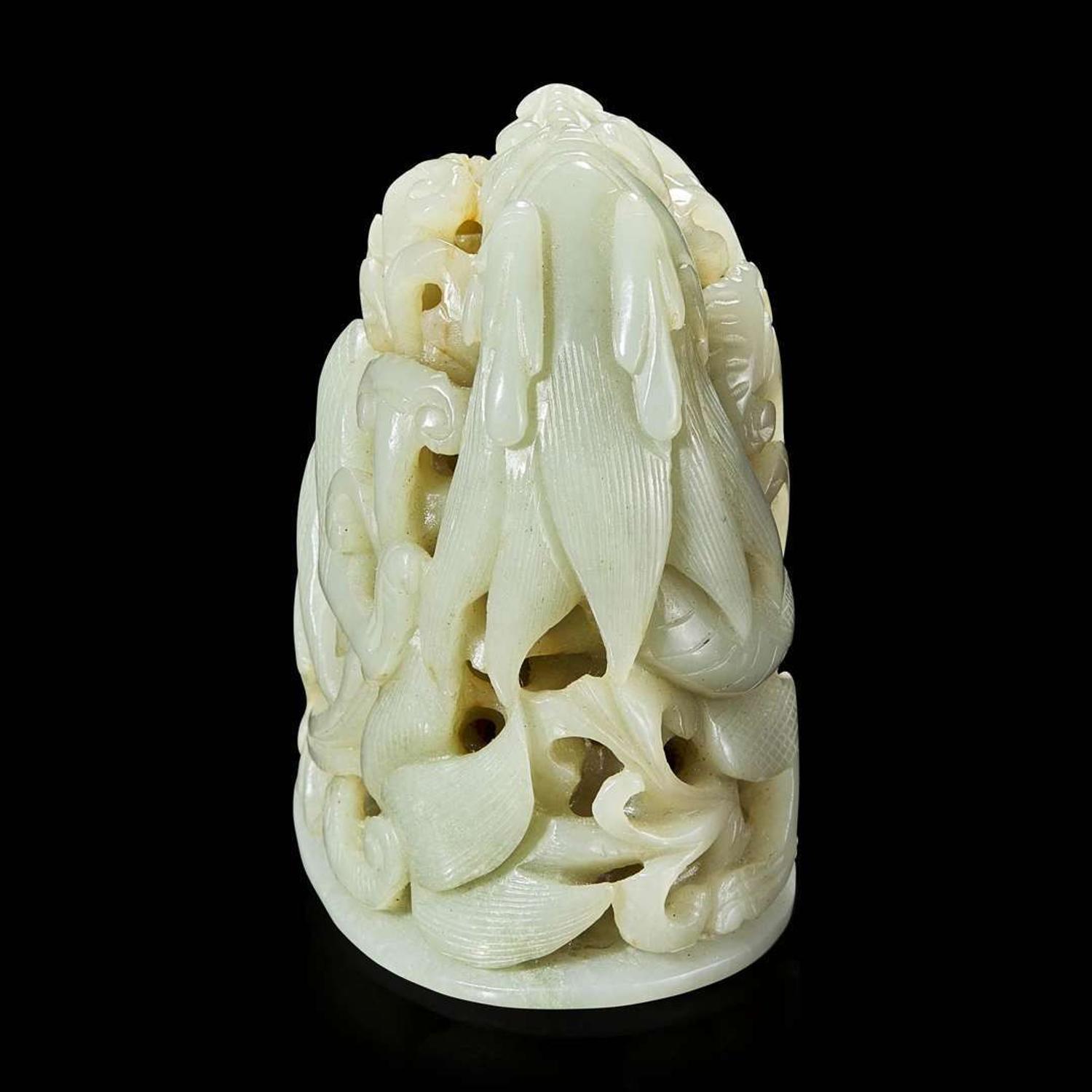 A Chinese pale celadon jade reticulated "Dragon" finial 青白玉镂空龙形炉端