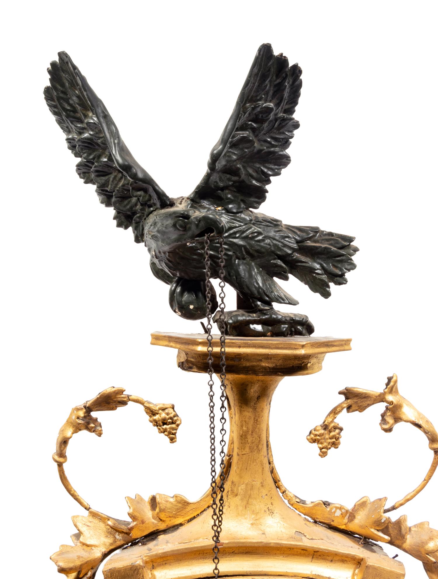 A Regency Parcel Ebonized Giltwood Girandole Mirror