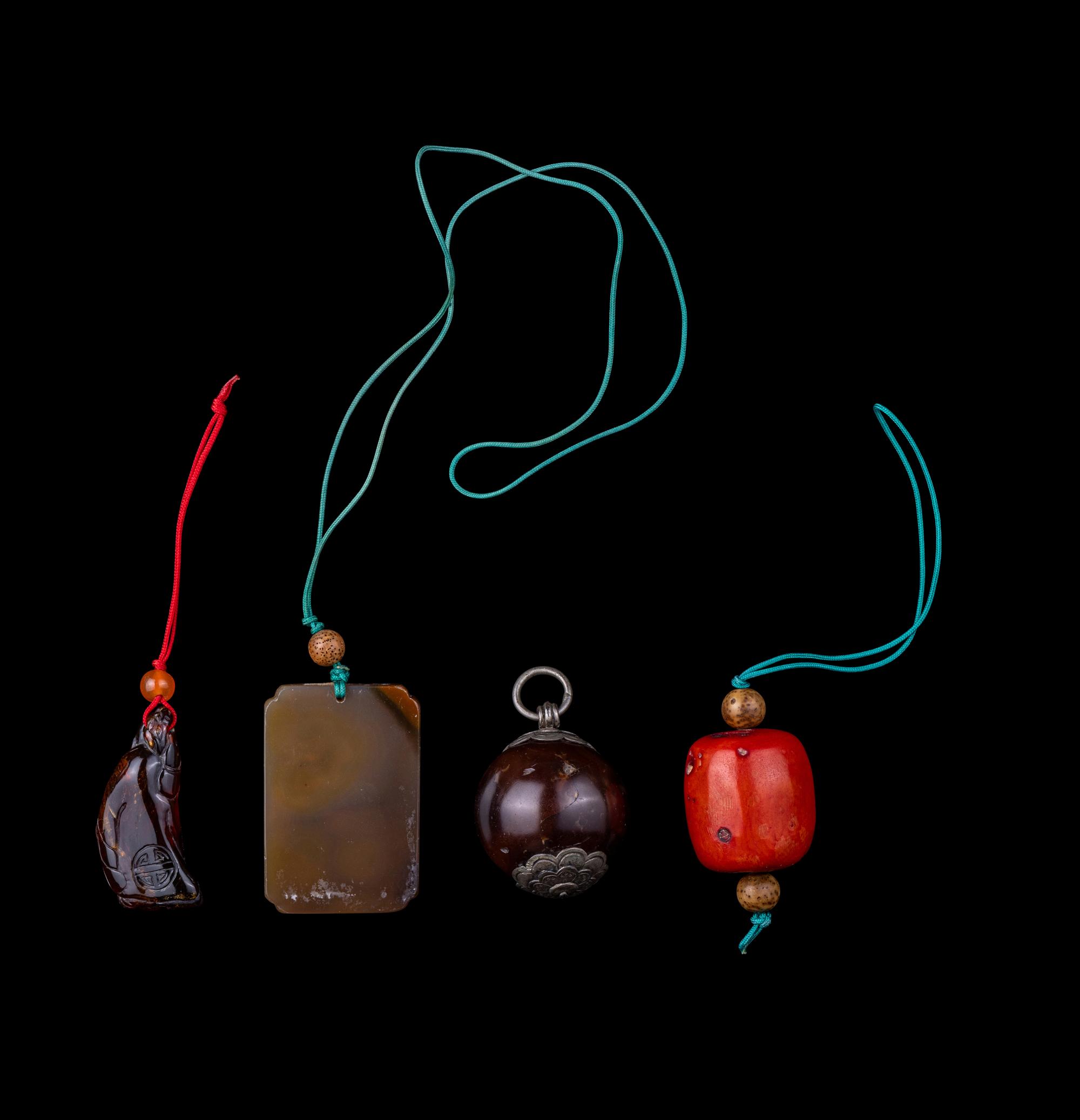 Four Chinese Amber, Agate, Coral and Hardstone Pendants