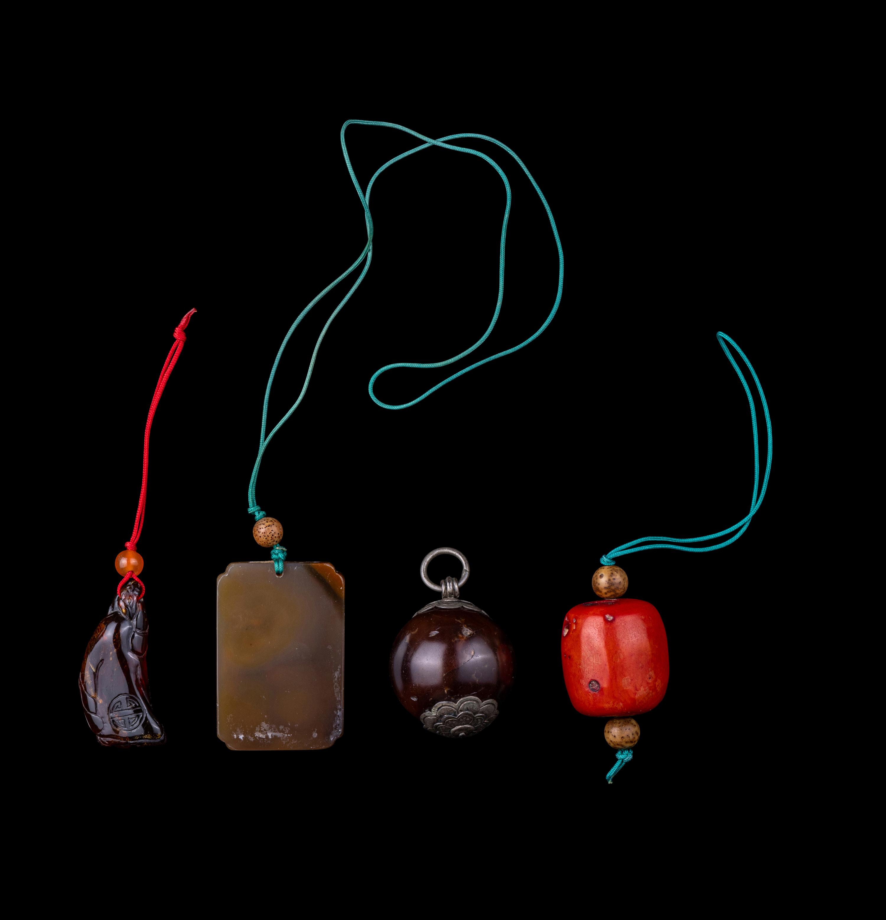 Four Chinese Amber, Agate, Coral and Hardstone Pendants