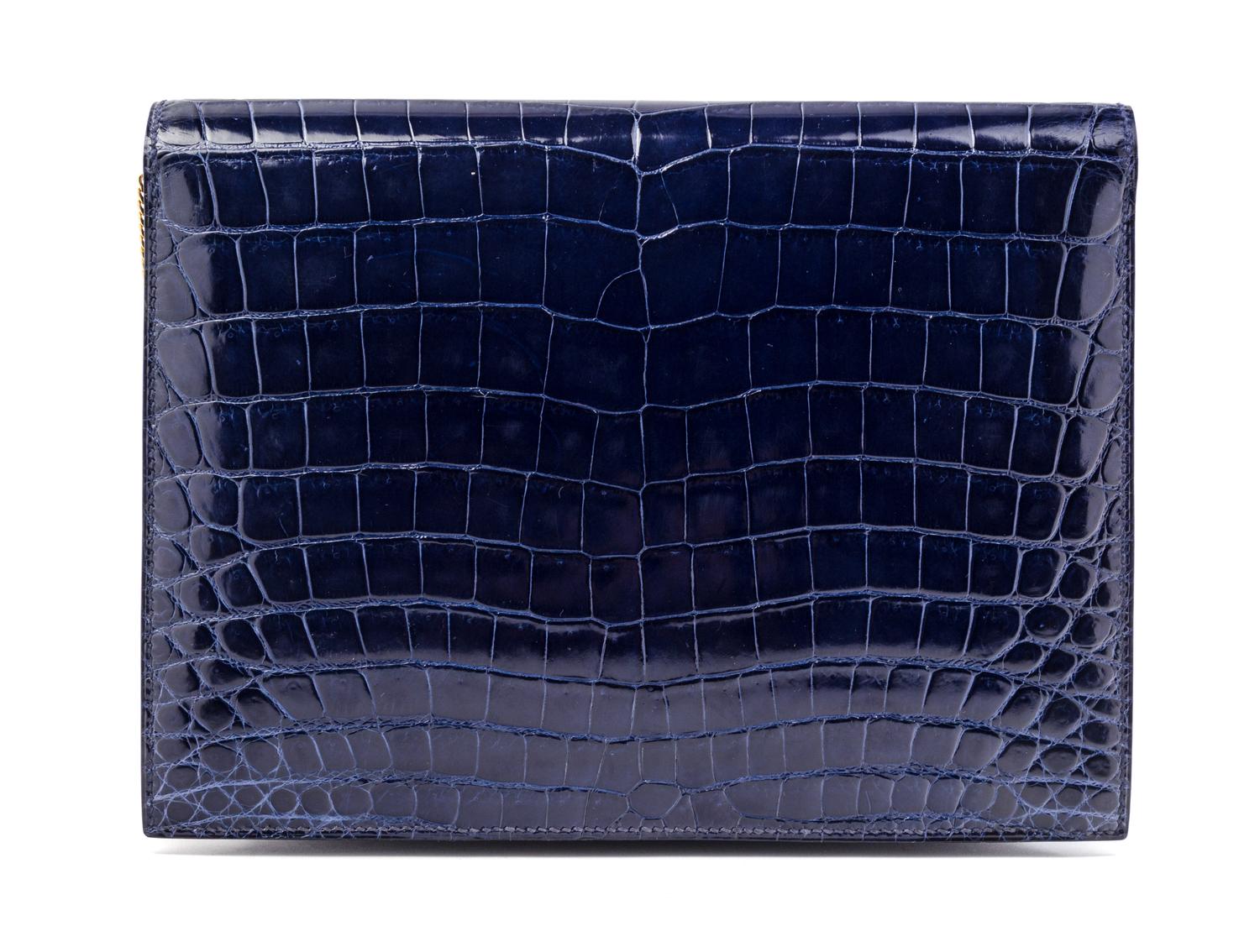 An Hermes Navy Niloticus Crocodile Faco Clutch, 9.25" x 7" x 1".