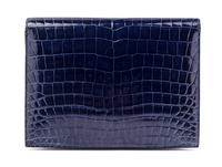 An Hermes Navy Niloticus Crocodile Faco Clutch, 9.25" x 7" x 1".