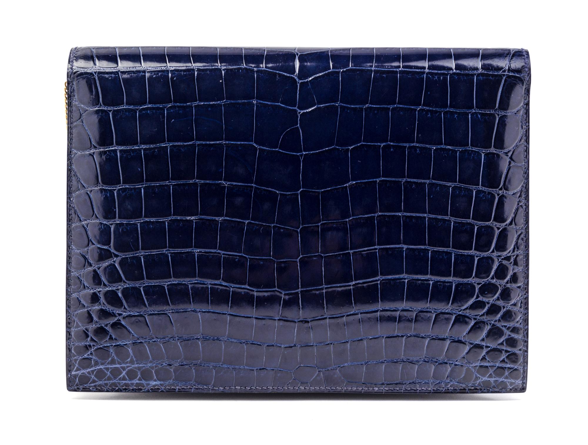 An Hermes Navy Niloticus Crocodile Faco Clutch, 9.25" x 7" x 1".