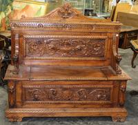 A Victorian Carved Oak Hall Bench. Height 56 inches.