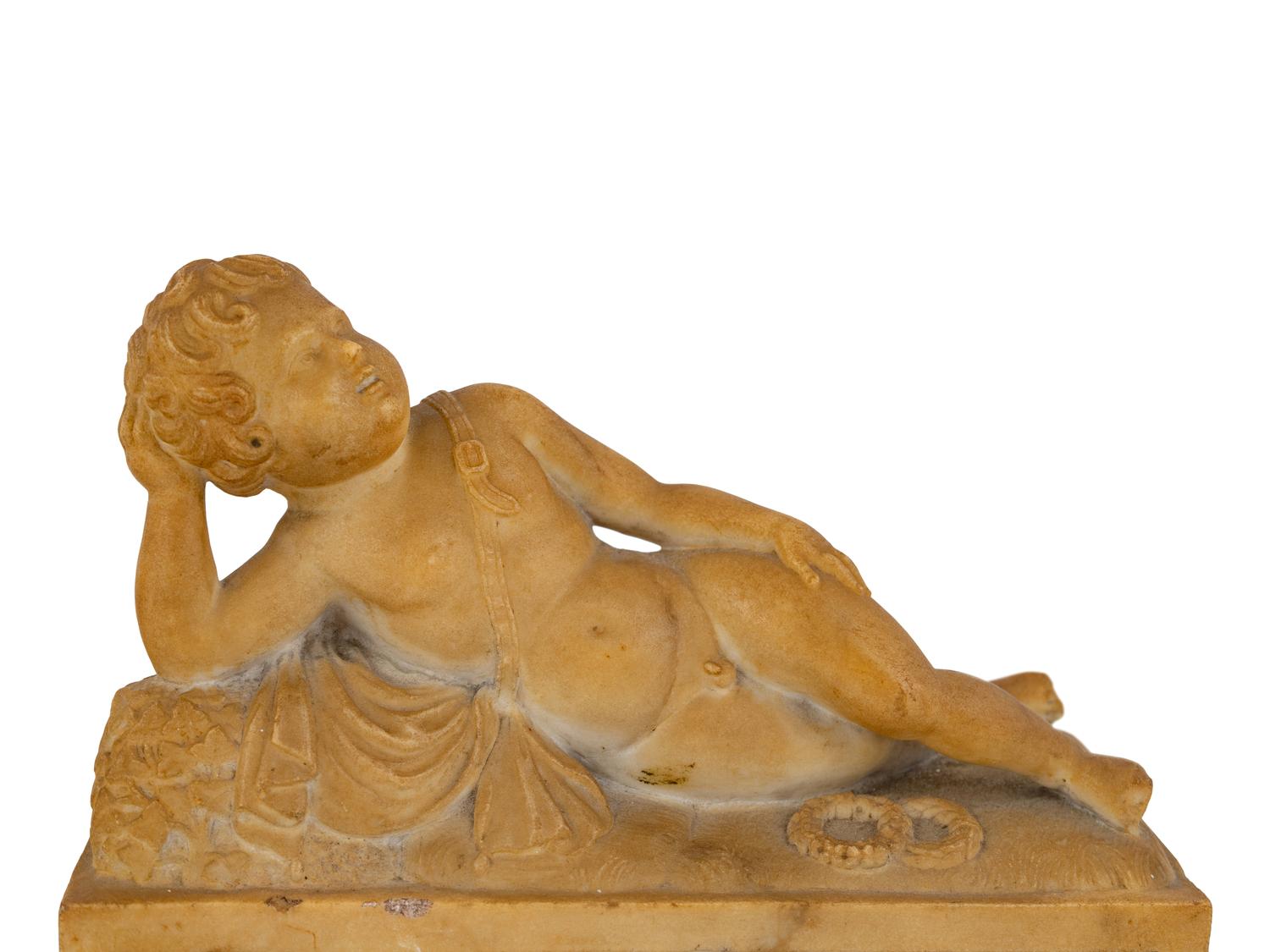 A Pair of Marble Models of Sleeping Cherubs on Plinths