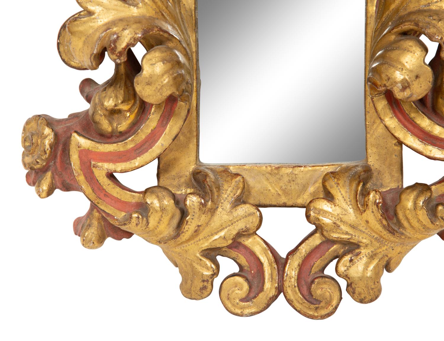 An Italian Rococo Style Red and Parcel Gilt Carved Wood Mirror