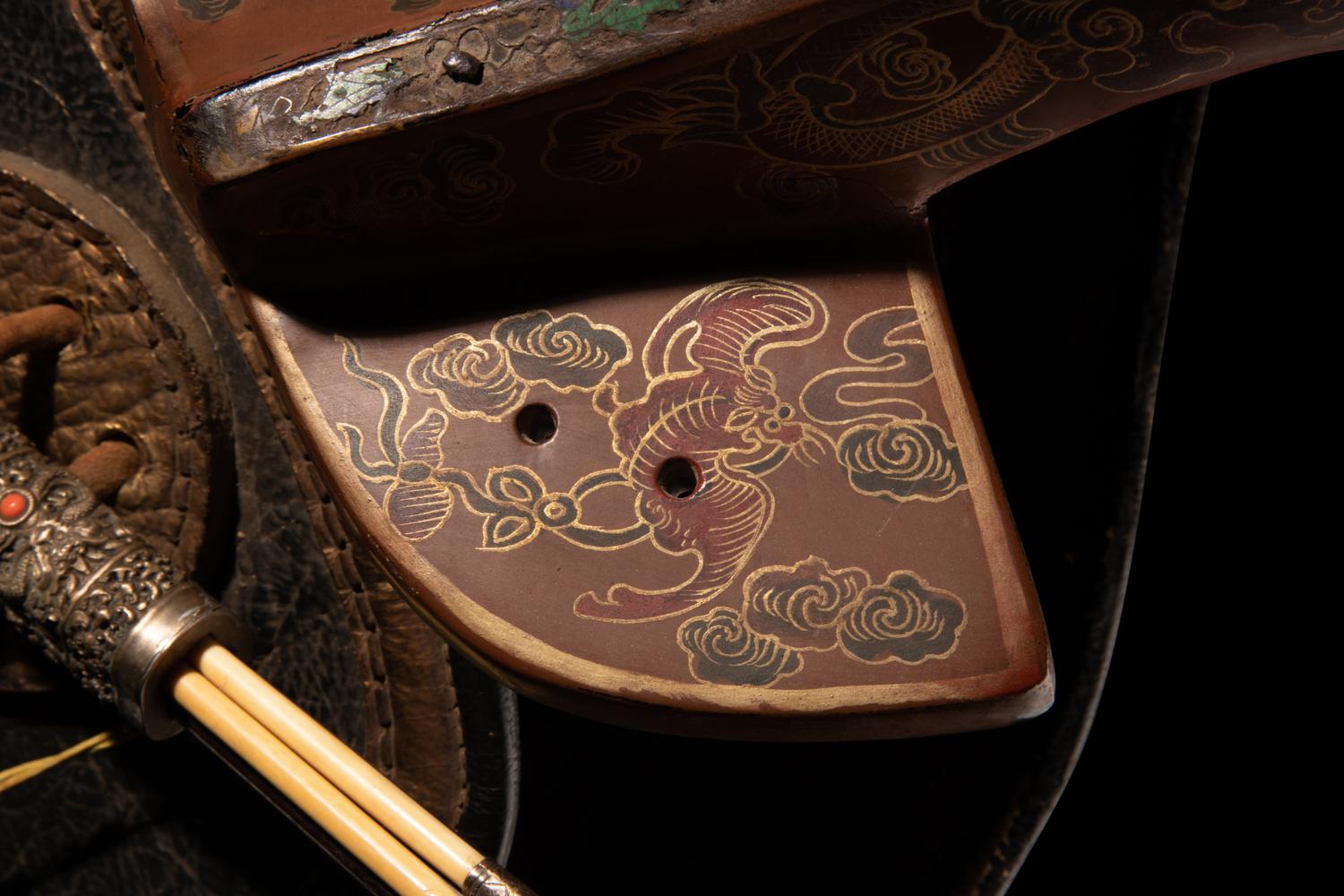 A Gilt and Polychrome Painted Red Lacquer Saddle and Two Pads