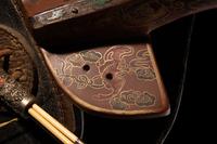 A Gilt and Polychrome Painted Red Lacquer Saddle and Two Pads