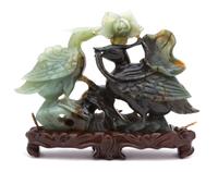 A Chinese Carved Jadeite Model of Two Birds with Lotus Blossom Height 6 1/2 x width 9 1/2 inches. — LATE 19TH/EARLY 20TH CENTURY