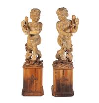A Pair of Florentine Carved Walnut Figures of Putti on Plinths