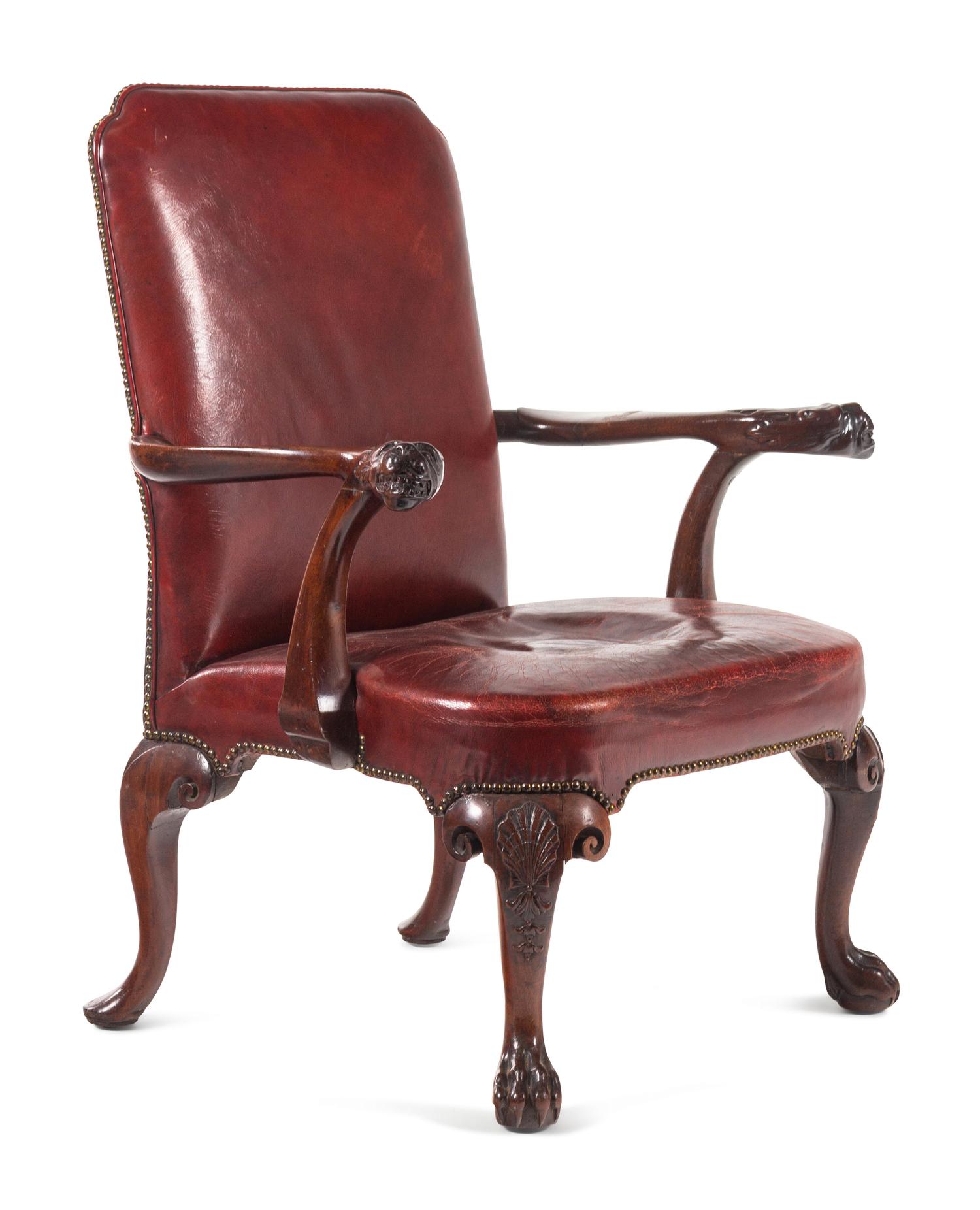A George II Leather-Upholstered Carved Mahogany Library Chair