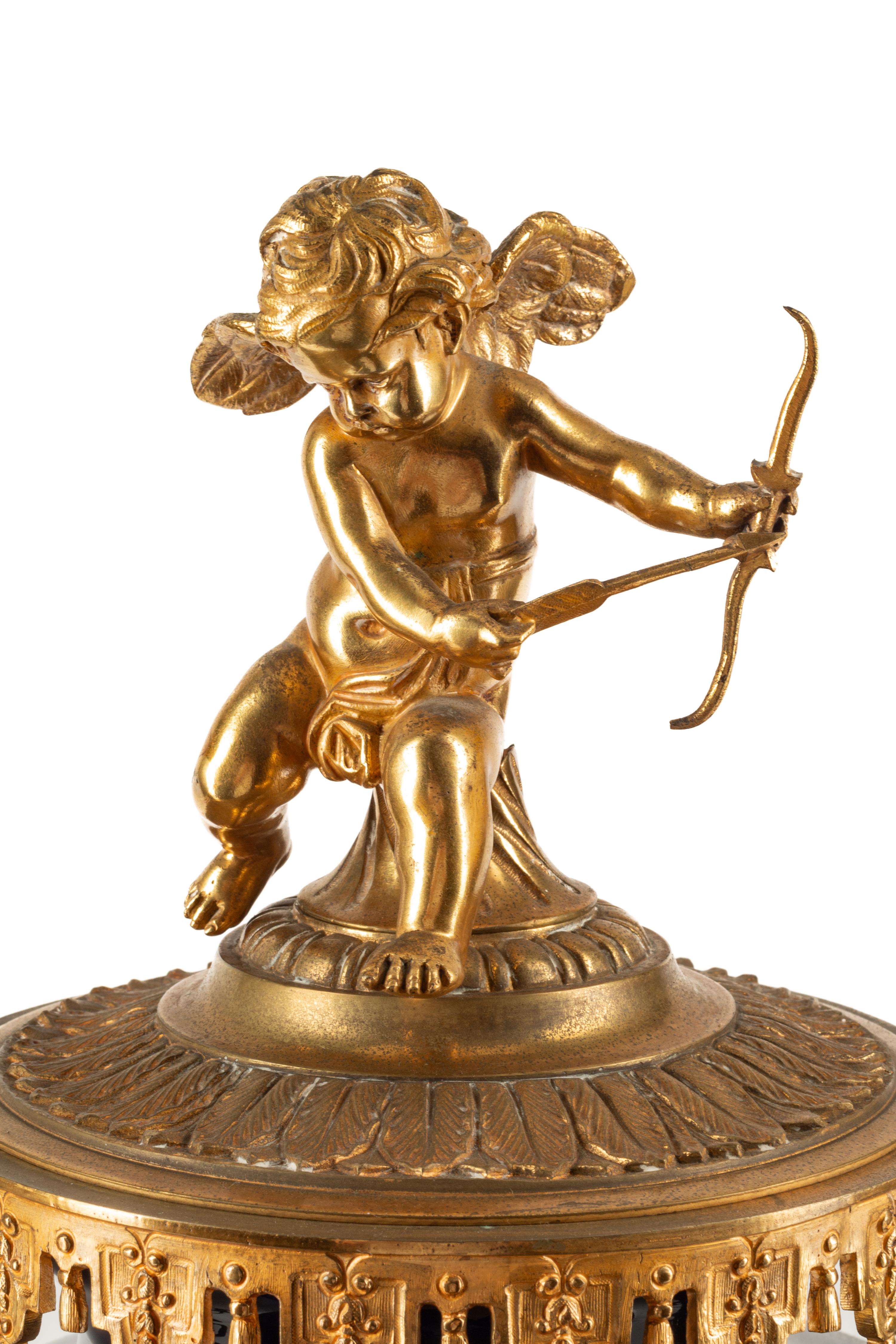 A French Gilt Bronze and Sèvres Style Porcelain Clock Garniture