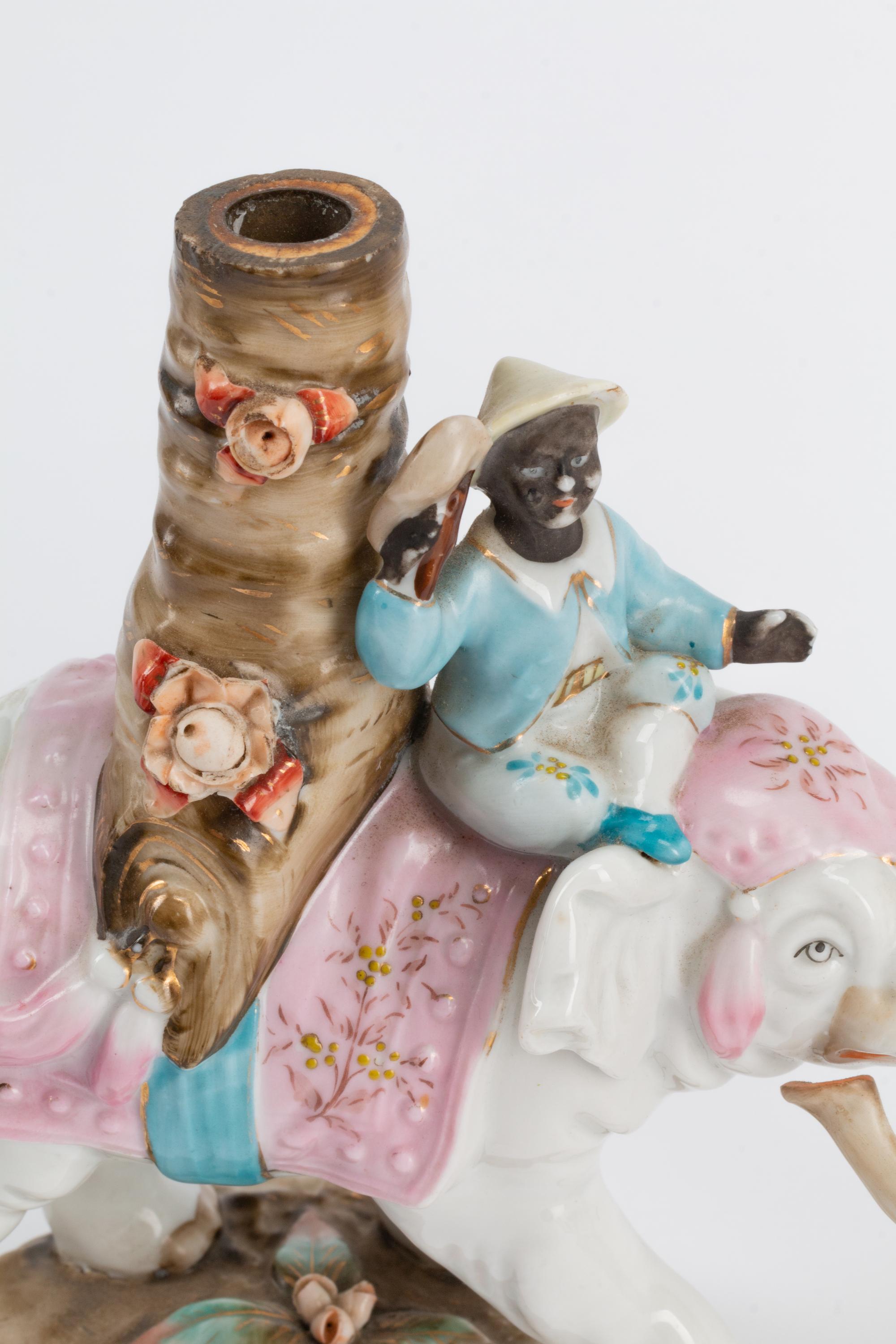 A Pair of Continental Porcelain Figural Candlesticks
