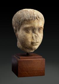 A Roman Marble Head of a Youth Height 8 inches. — CIRCA 2ND CENTURY C.E.