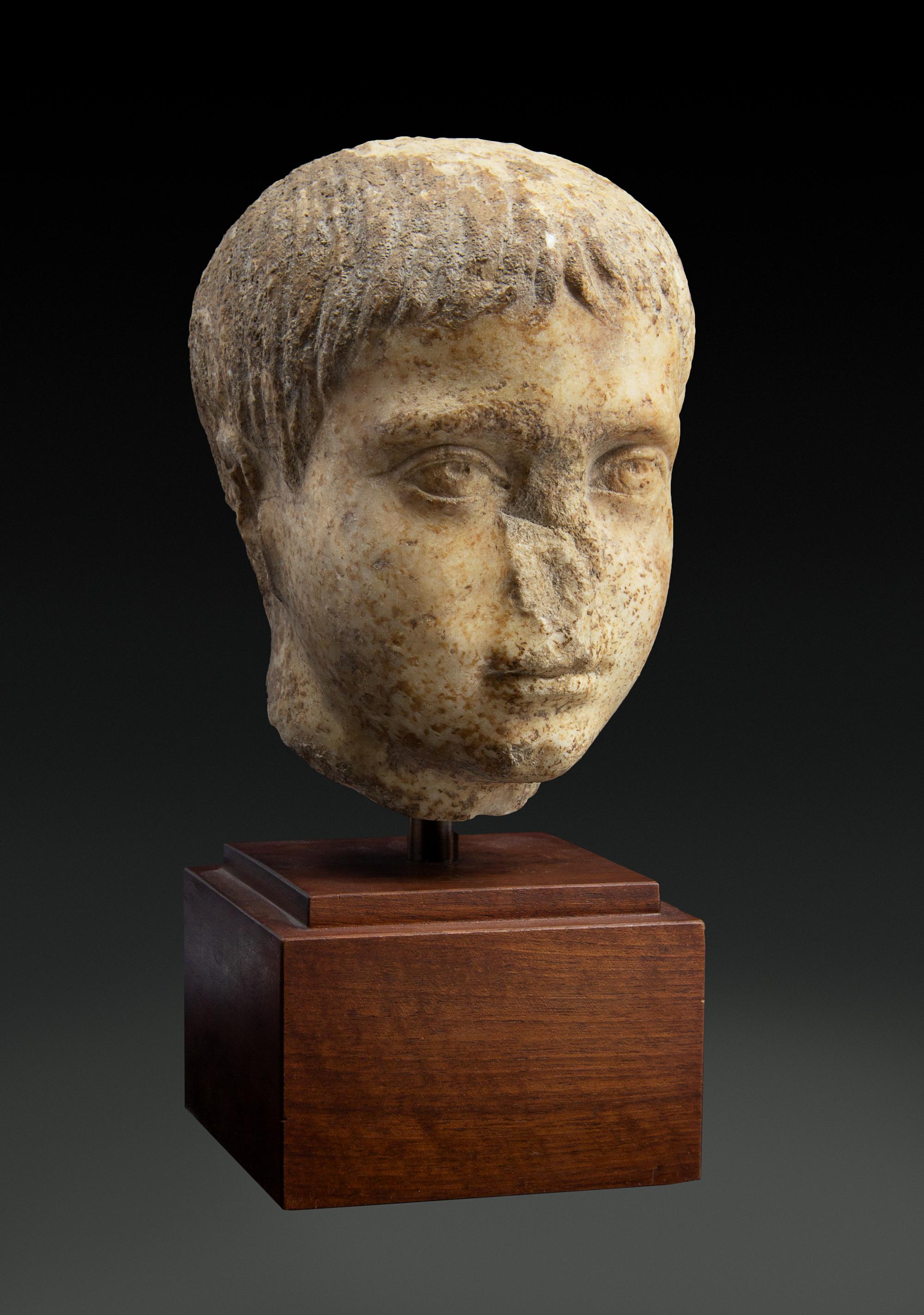 A Roman Marble Head of a Youth Height 8 inches. — CIRCA 2ND CENTURY C.E.