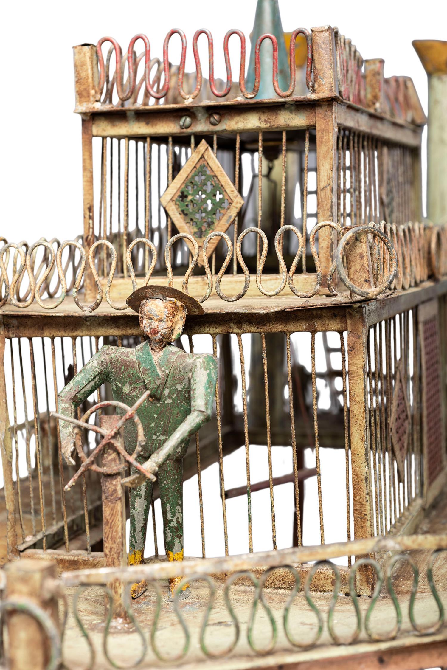 A Folk Art Cut and Painted Metal Paddleboat Form Birdcage