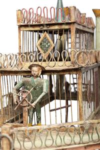 A Folk Art Cut and Painted Metal Paddleboat Form Birdcage