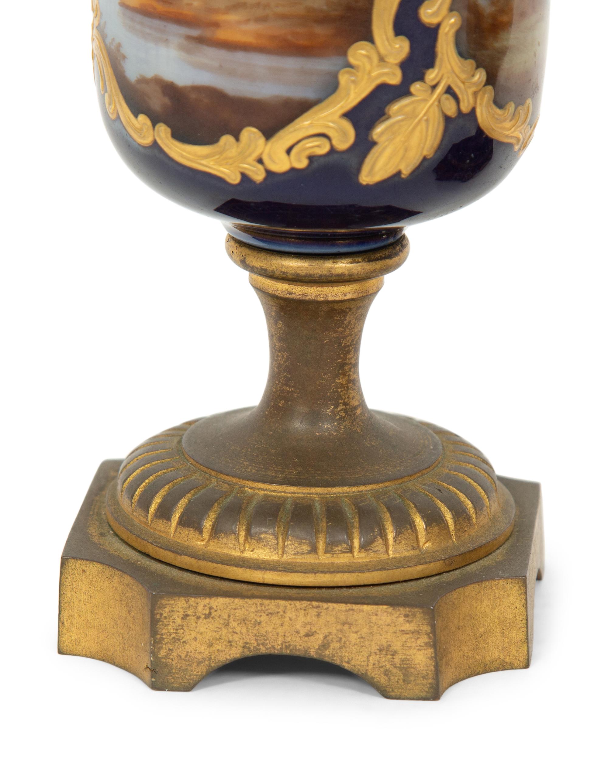 A Pair of Small Sevrés Style Porcelain and Gilt Bronze Urns