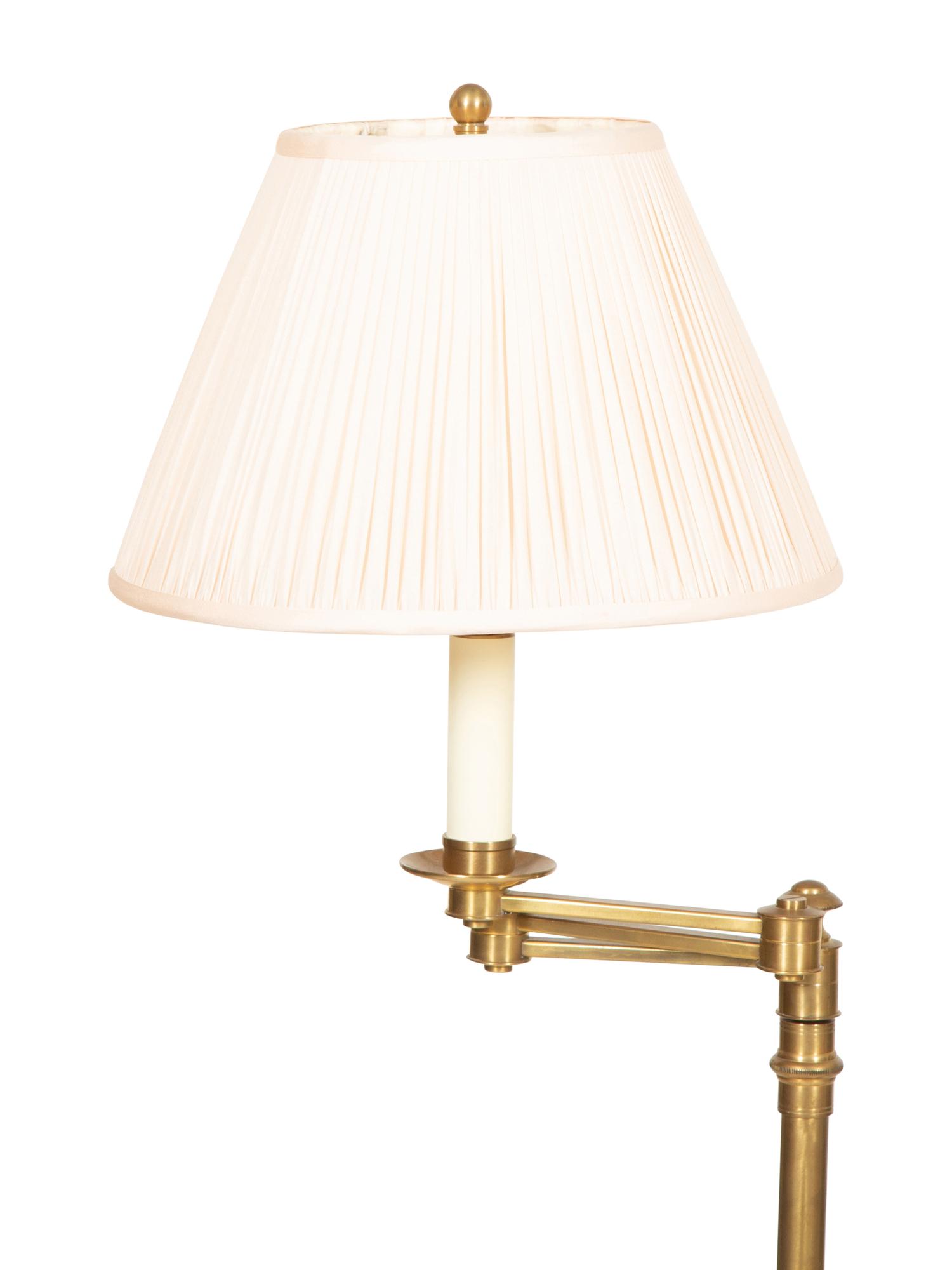 A Group of Four Brass Adjustable Floor Lamps