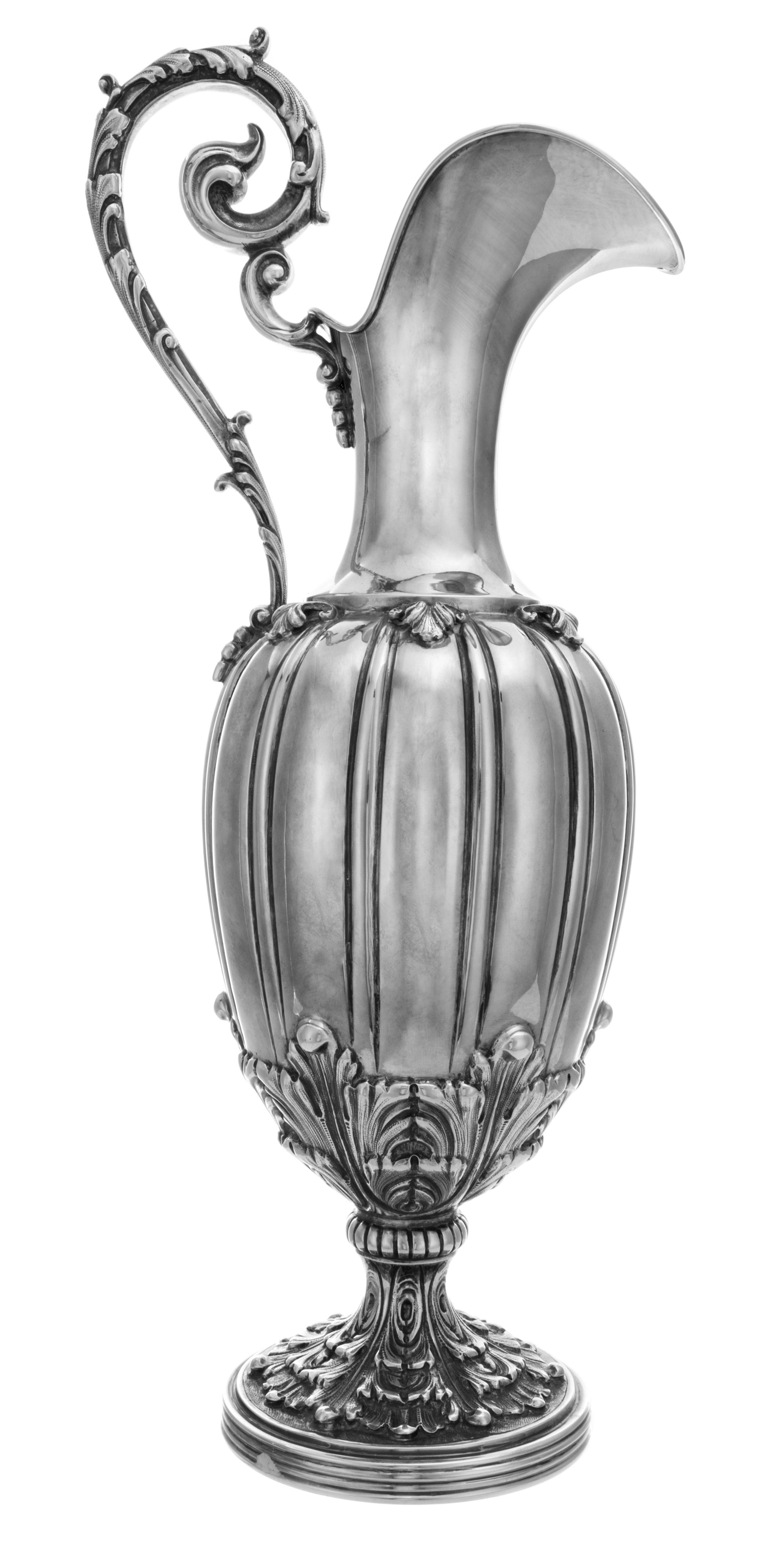 An Italian Silver Wine Ewer, Buccellati, Milan, having a foliate scroll handle surmounting a ribbed, melon form body and raised on a fo
