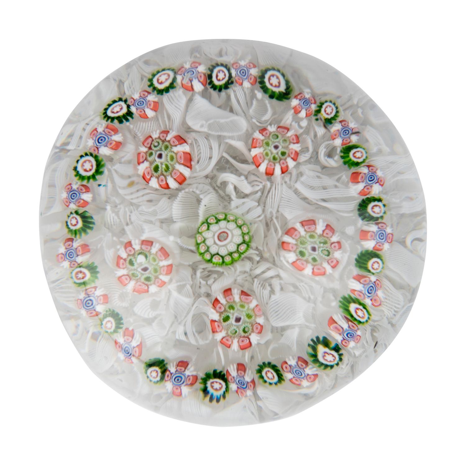 A Spaced Concentric Millefiori Over Upset Muslin Glass Paperweight