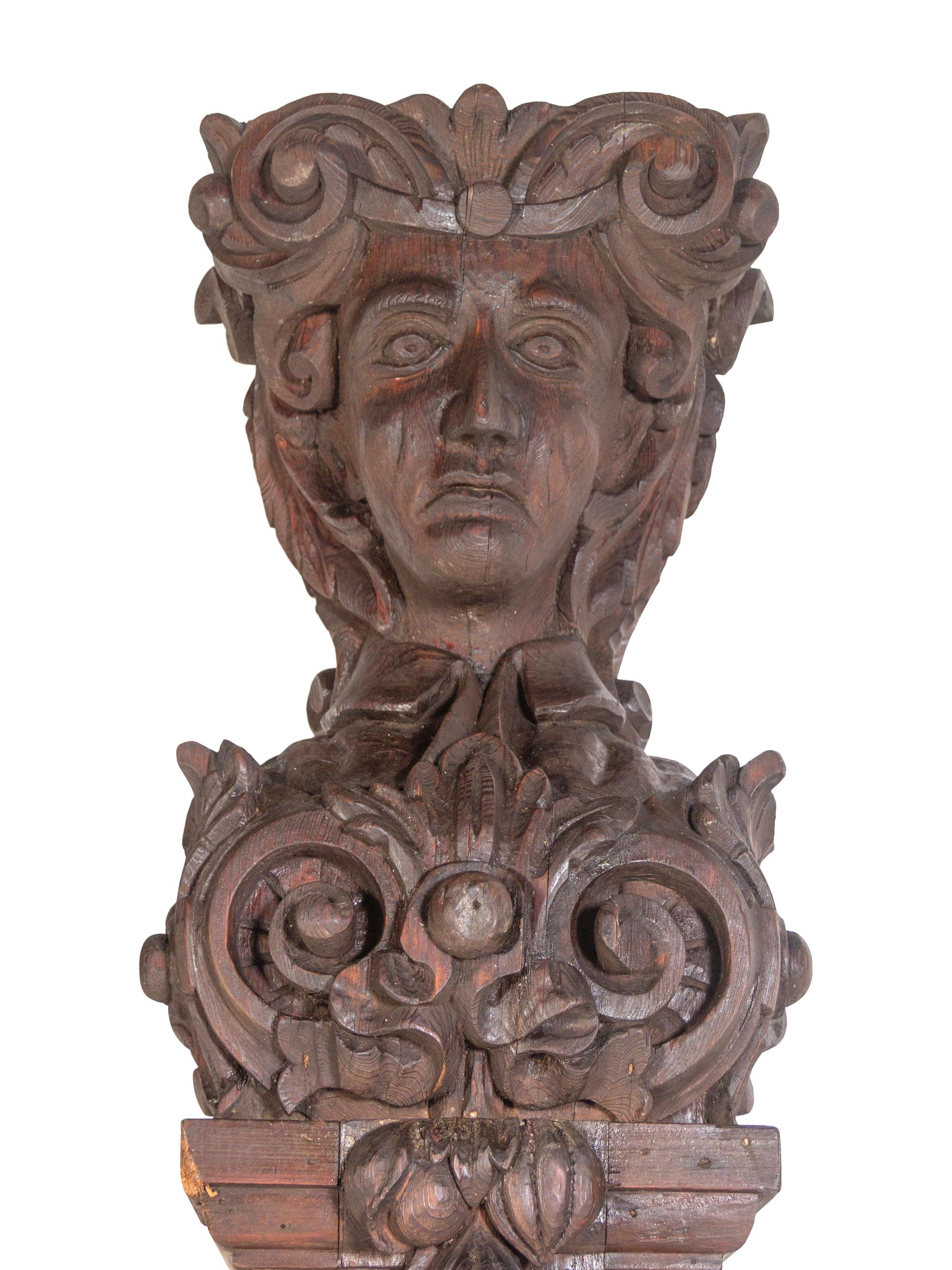 A Pair of Continental Carved Oak Figural Pilasters