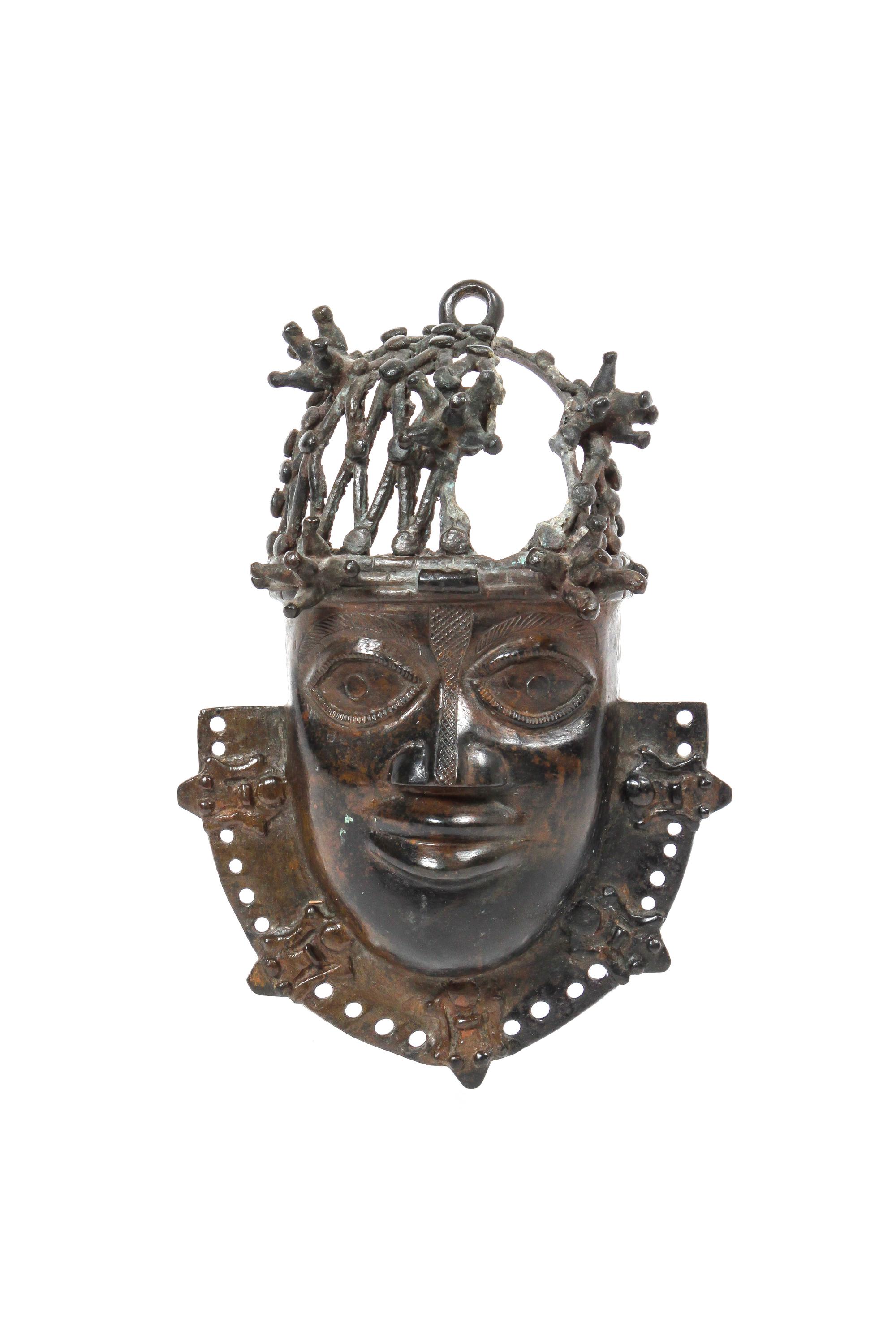 A Benin Bronze Mask Height 7 1/2 x width 4 3/4 x depth 2 3/4 inches.