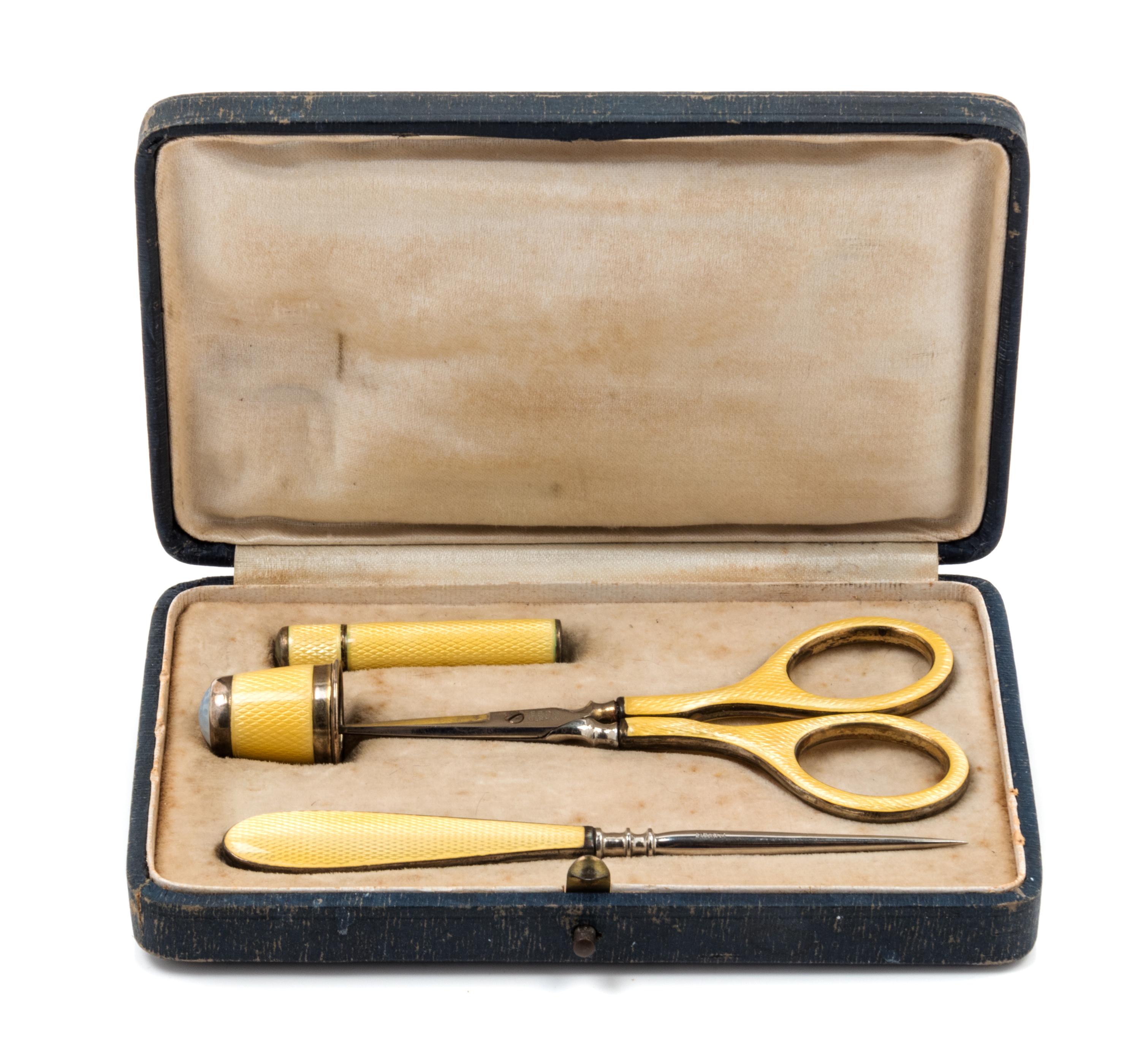 A German Silver and Guilloche Enamel Four-Piece Sewing Kit, , comprising scissors, a thimble, a stiletto and a needle case, each item w