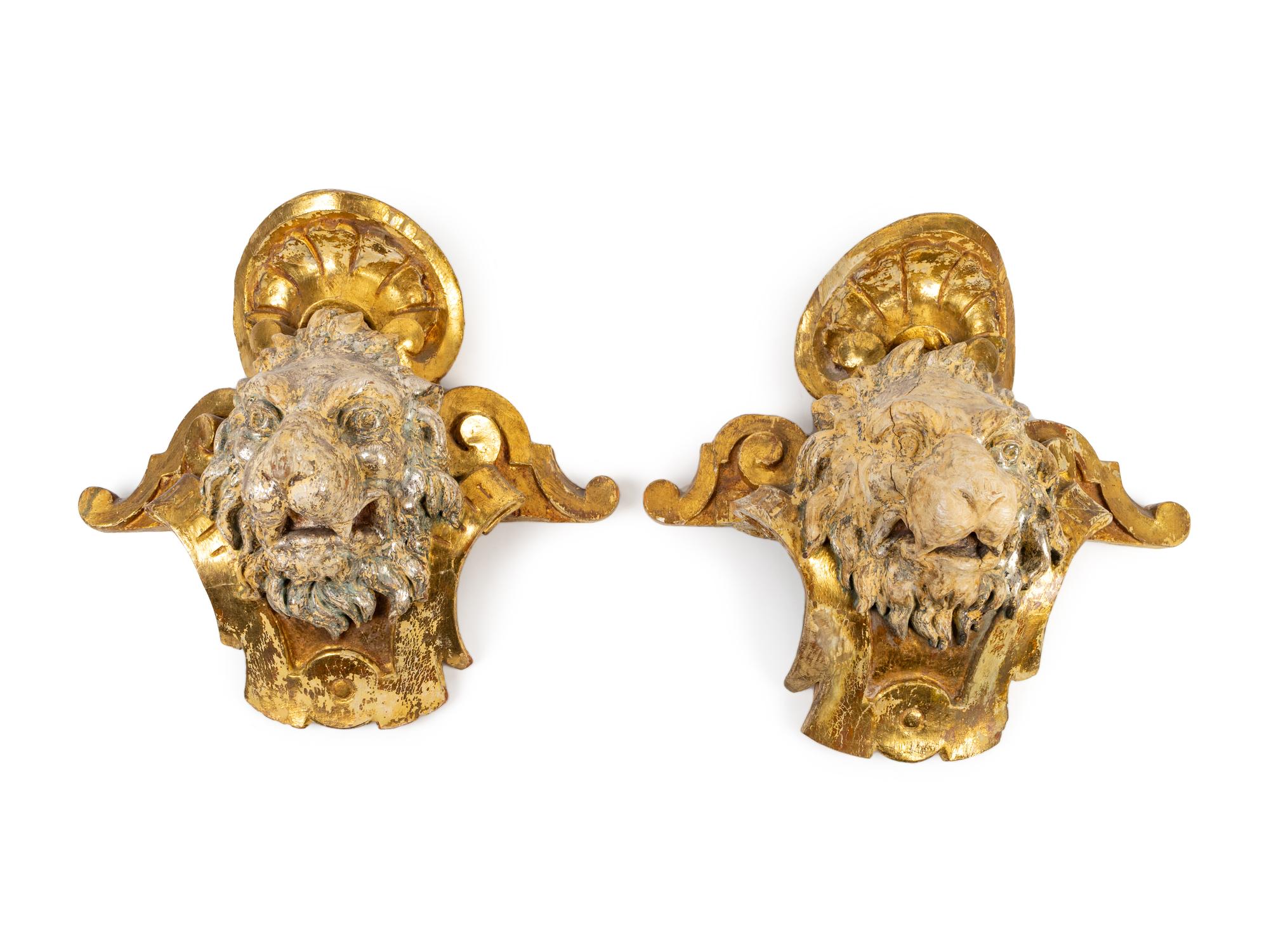 A Pair of English Part Silvered Giltwood Lion Masks — SECOND QUARTER 19TH CENTURY