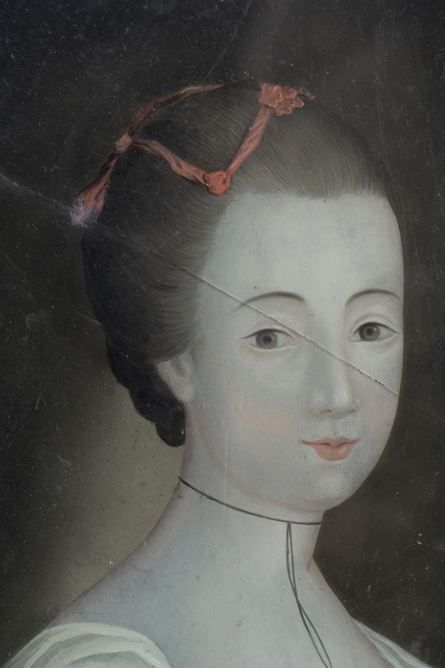 A Pair of English Reverse-Painted Glass Portraits