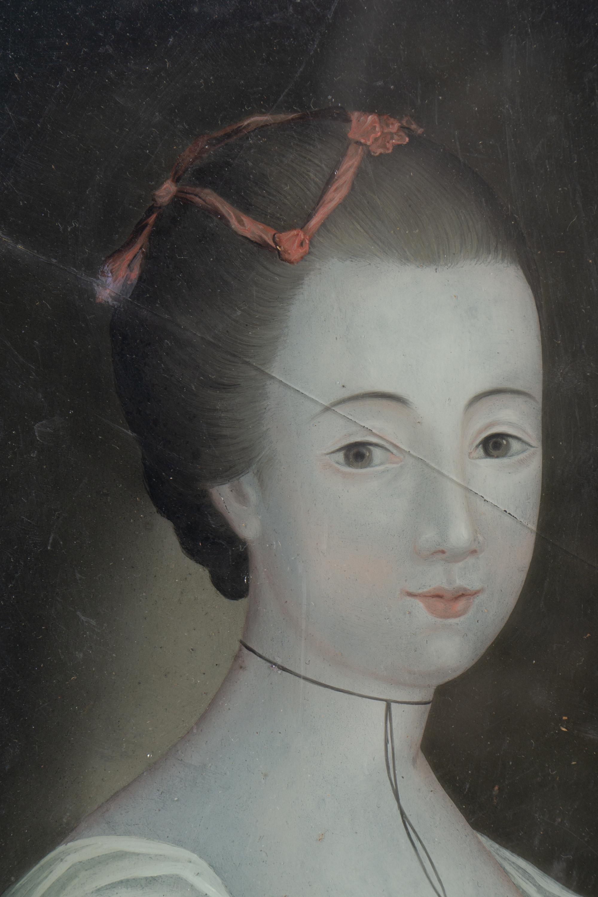 A Pair of English Reverse-Painted Glass Portraits