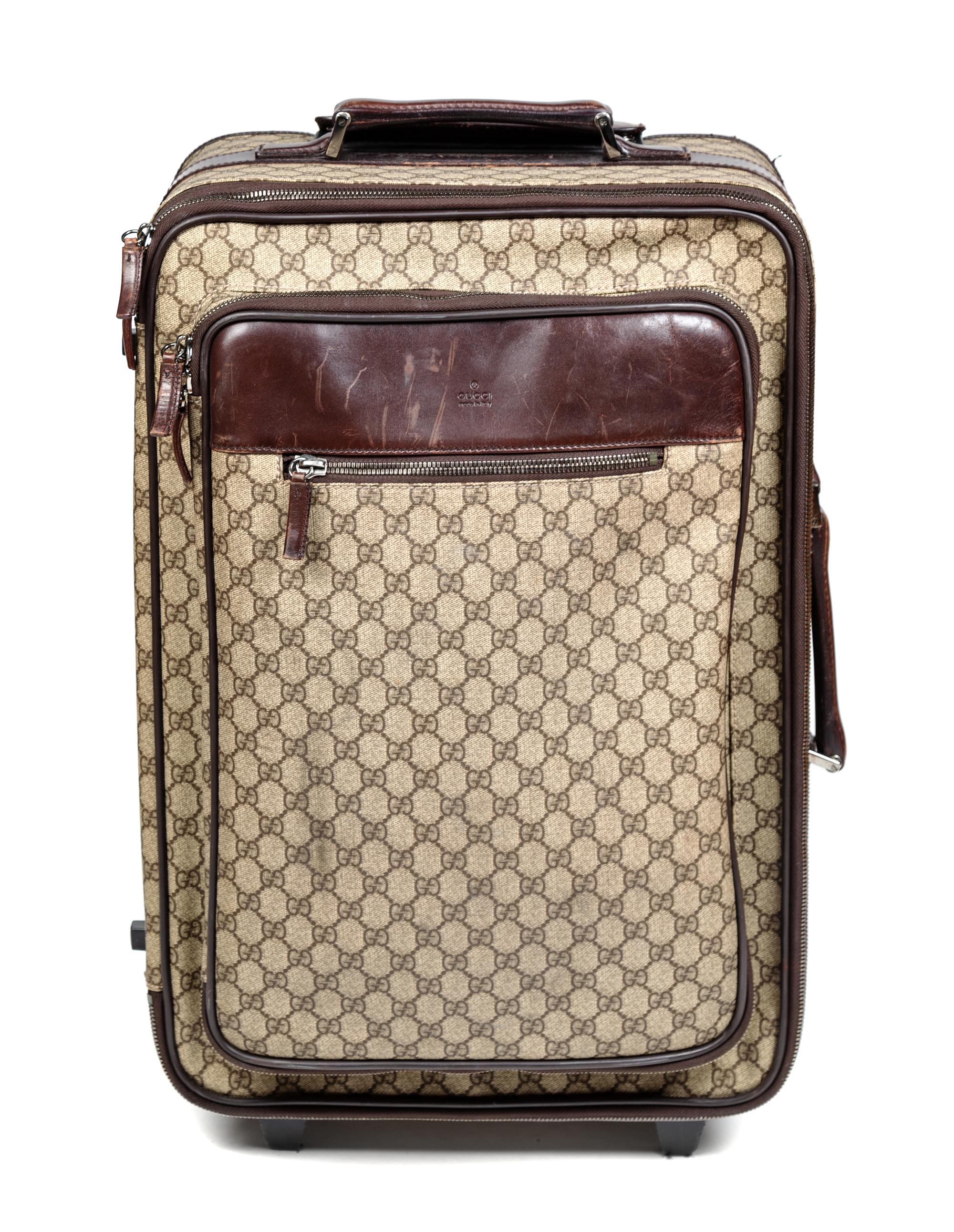 A Gucci Monogram Canvas Roller Suitcase, 22" H x 15.25" W x 9.25" D; Handle: 1.25".