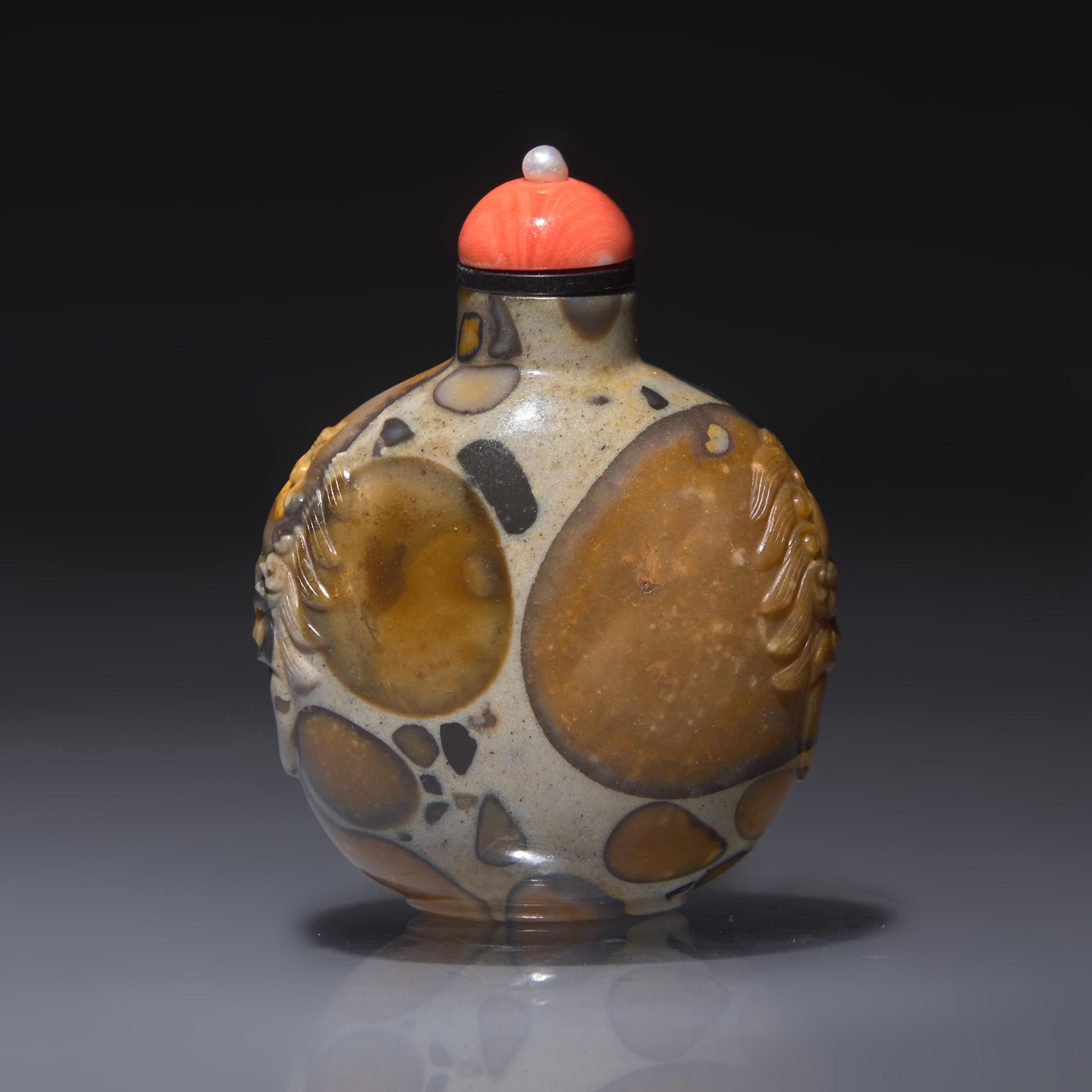 A Chinese Carved Puddingstone Snuff Bottle, Qing Dynasty, Circa 1750-1820 — 1750-1820年 抱子石鋪首啣環耳鼻煙壺
