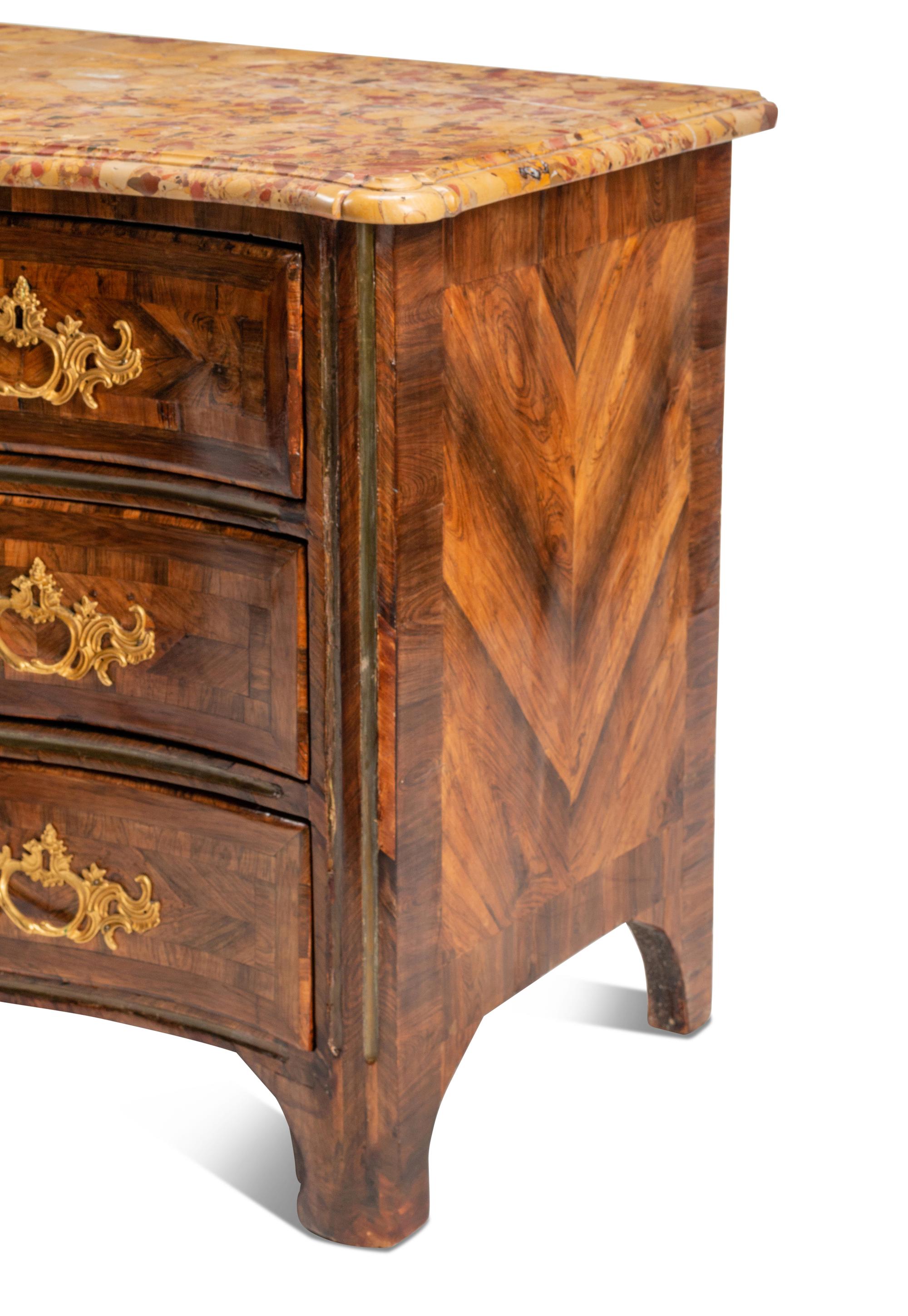 A Régence Gilt Bronze Mounted Tulipwood and Parquetry Marble-Top Commode