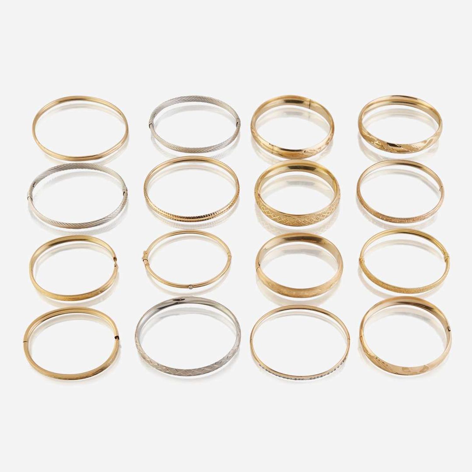A collection of sixteen fourteen karat gold bangles