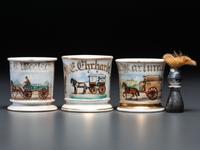 Three Porcelain Occupational Shaving Mugs with Horse-Drawn Carts