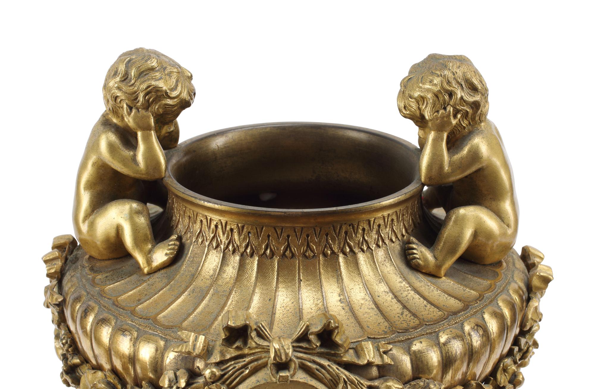 A French Gilt Bronze and Specimen Marble Three-Piece Clock Garniture