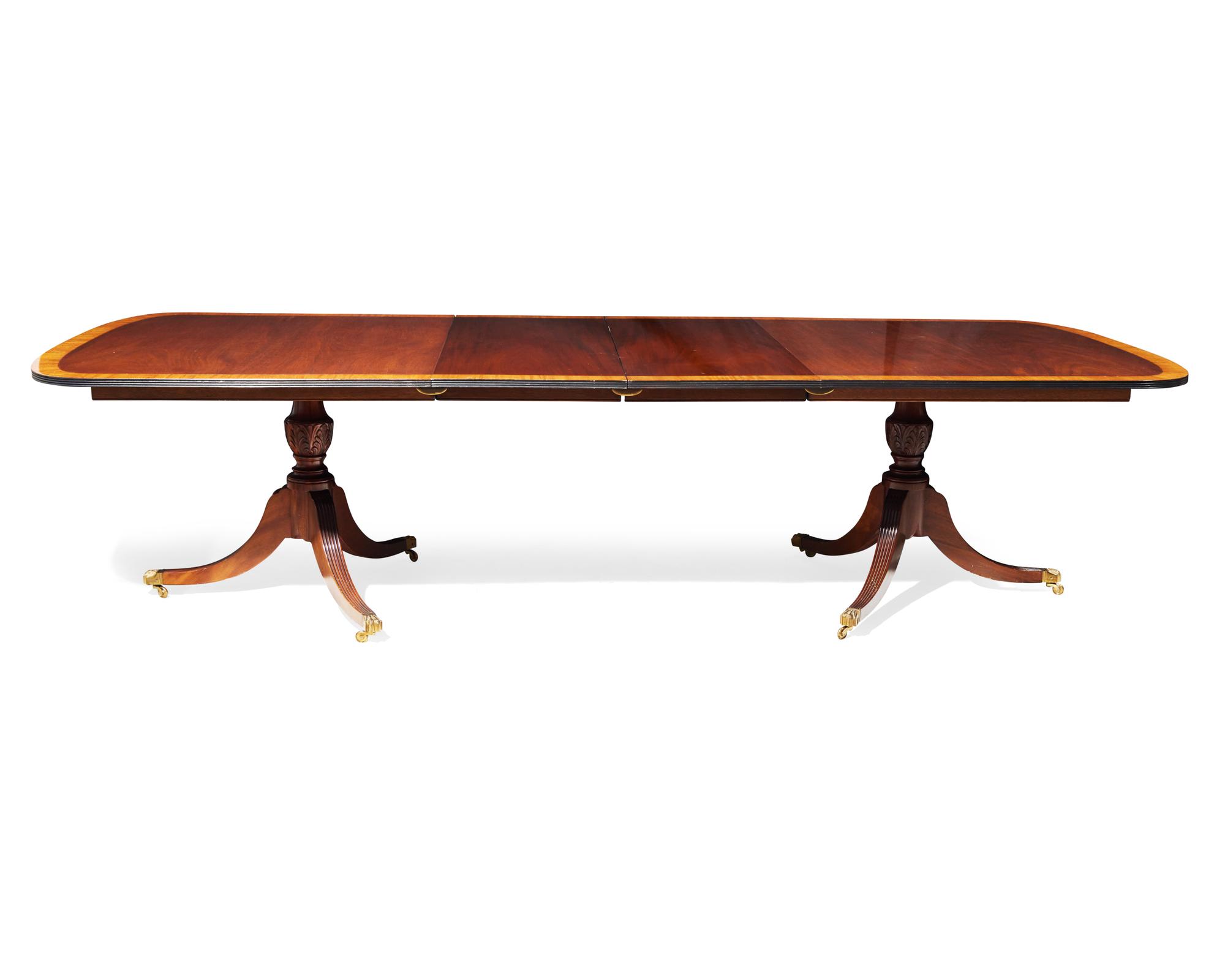 A Regency style two-pedestal inlaid mahogany and satinwood dining table, 20th century